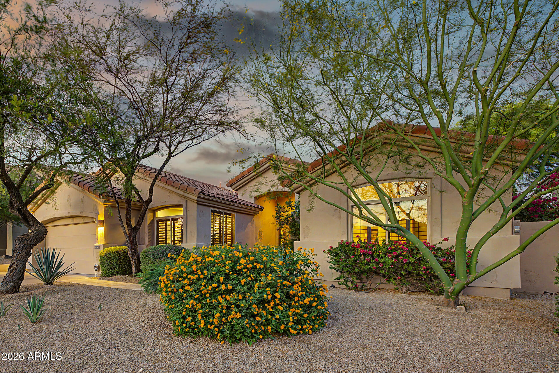 Excellent curb appeal & stunning desert landscaping set the tone for this beautiful turn-key home! Inside, plantation shutters, vaulted ceilings, & an open-concept layout create a bright & inviting atmosphere. Offering 3 bedrooms + a double-door office & a living area centered around a cozy fireplace! Remodeled Chef's kitchen has granite counters, popular white cabinetry w/crown moulding, SS appliances, subway tile backsplash, & center island for prep & breakfast bar. Luxurious primary retreat offers backyard access, high ceilings, & spa-inspired ensuite w/dual sinks, tiled shower, & mirrored door walk-in closet. 20+ championship golf courses within 10 miles, and minutes from the 101! Oasis-style backyard enjoys a sparkling pool w/boulder waterfall, flagstone flooring, colorful desert landscaping, full-length covered patio w/misting system, putting green, fireplace, & built-in BBQ. Plus, solar panels & NO neighbors behind! Exceptional privacy & views of Pinnacle Peak & the McDowell Mountains. Great location near premier golf, dining & hiking. See it, love it, live it!
