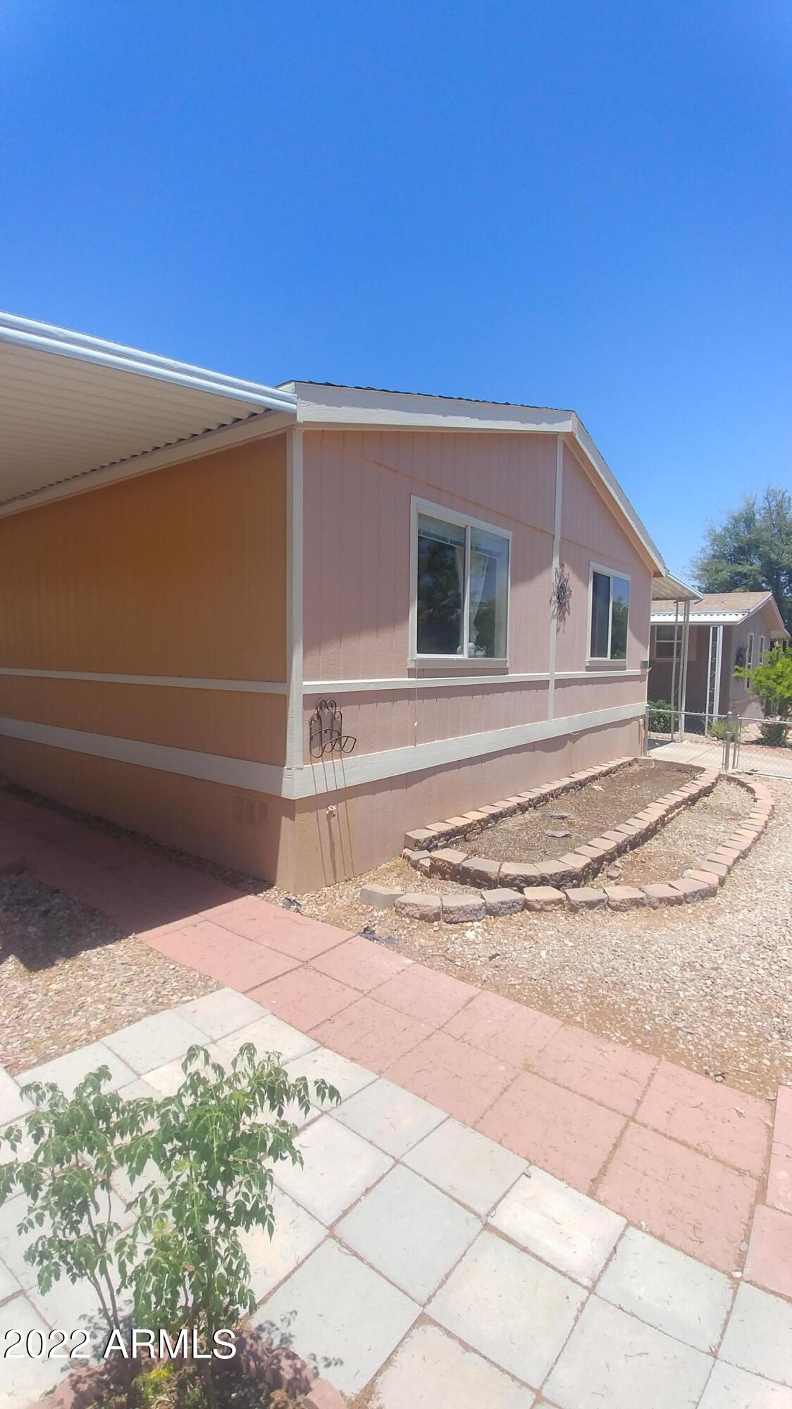 Motivated Seller. 3 bedroom, 2 full bath with formal living room and family room. Approximately 1,792 square feet of living space offers all spacious rooms. Open floor plan. New gas stove, garbage disposal and dishwasher. Ceramic tile in kitchen, utility room and hall bath. New laminate flooring in all other areas. Split bedroom plan. Large utility room. Home includes a nice sized shed and chain link fenced yard. Gated Community offers 2 club houses, 2 pools (one is indoor), spa. Lot rent includes cable, trash, sewer and water.