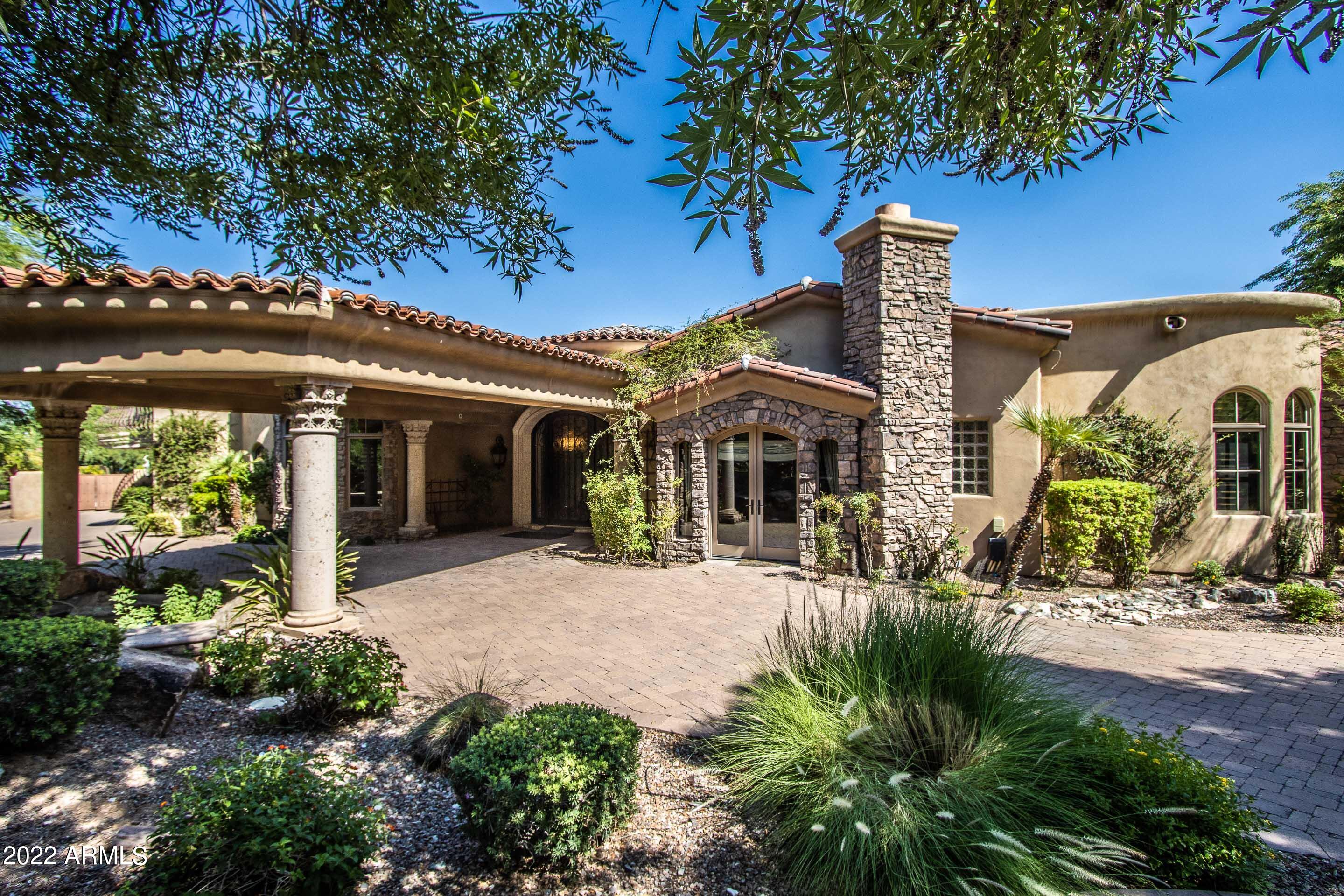 REDUCED! VIEWS! VIEWS! Circular drive to the Porte Cochere welcomes you to this wonderful estate. Grand foyer with 18'' Dome ceiling. Cantara stone flooring.  Awesome views from every room. Beautiful Mediterranean pool and spa. Fabulous location in Paradise Valley.  Spacious guest suite with BR and DA accessible from the main property as well as a separate entrance. Home theater with a built in wet bar. Spacious Owner's Suite with sitting room. A Bath connects Office and Workout Rooms - all on the first level.  The second level features two bedrooms, 2 baths and a Bonus Room. Spacious formal dining room. The breakfast room overlooks the pool. FR features disappearing lanai doors. The 1st floor living space includes a bar with a wine room.  Four car garage with lots of storage.