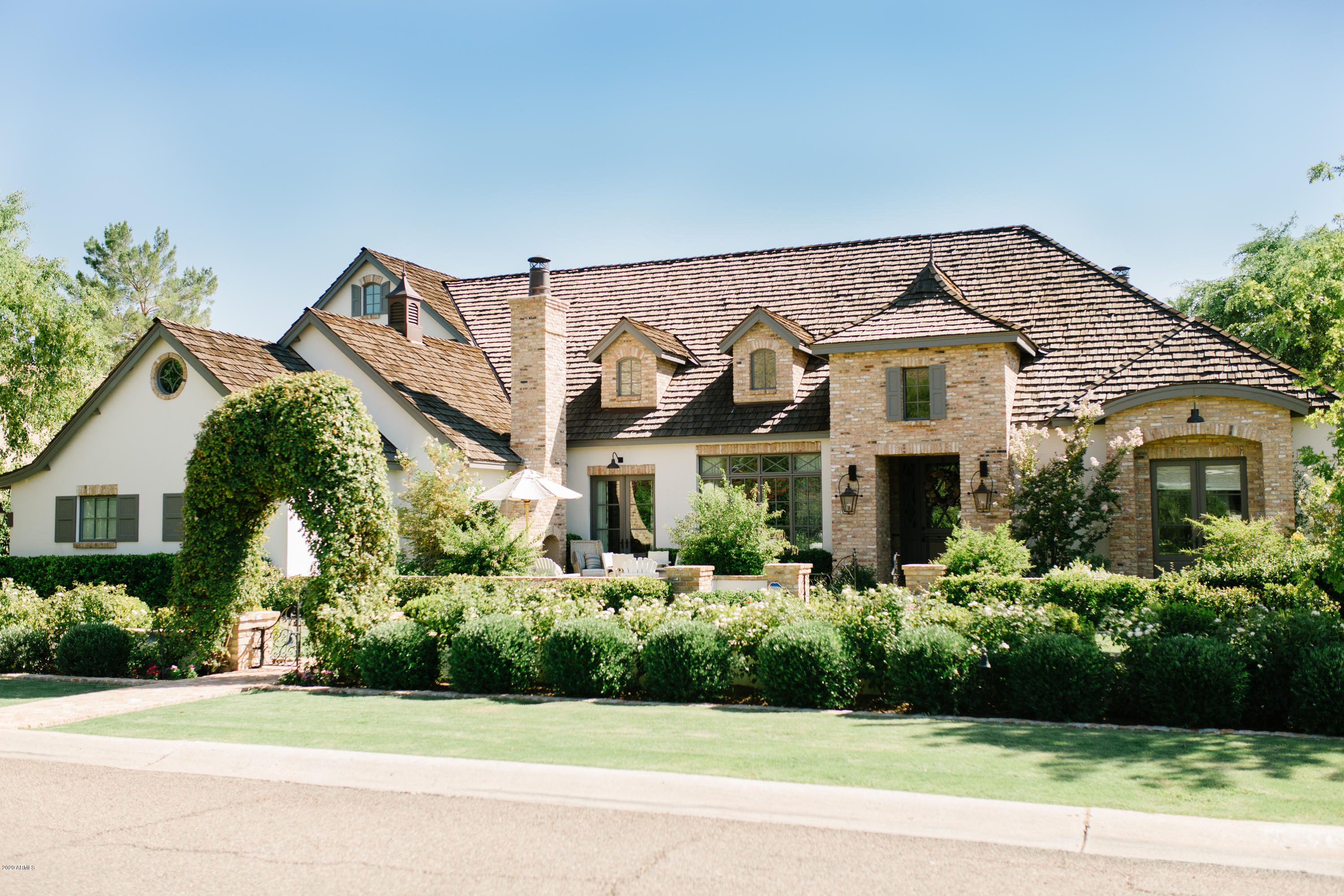 A true jewel box and a joy to share .Dreamy front patio with fireplace ,reclaimed brick, and fountain. Thru the dutch door you enter the foyer. Marble flooring flows onto reclaimed wood naturally. Look up at the millwork as it is one of many artesian features. Natural light floods the open concept family room and gourmet kitchen featuring soaring wood beams and antique limestone fireplace .The downstairs primary(master)suite with fireplace,custom closet and spacious bath also includes the perfect work at home office. Additional bedroom ensuite down with a bedroom ensuite upstairs. A 4th bedroom ensuite is easily converted .Antique doors built in plus the cutest laundry room ever ! The private backyard with covered patio, pool,sport court and lush landscape make staying at home a pleasure.