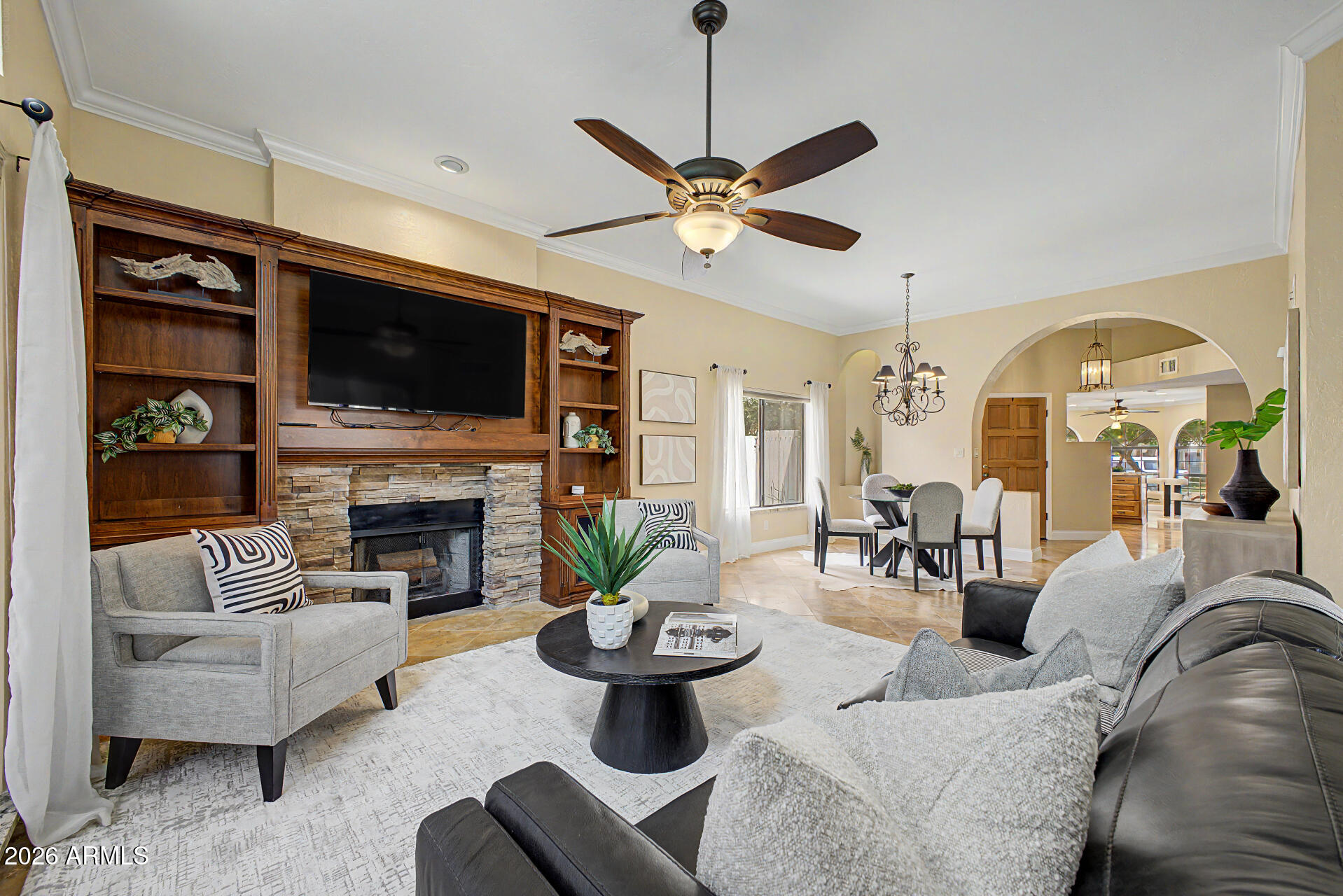 Beautiful single-story townhouse offering the perfect lock-and-leave lifestyle in a prime North Phoenix location. This 2 bed, 2 bath + den home features an open layout with warm wood cabinetry, granite countertops, and abundant natural light. Spacious living area with custom built-ins and cozy fireplace. Private backyard retreat with paver patio, artificial turf, and mature desert landscaping on drip system. Adjacent to Stonecreek Golf Course and near Cholla Cove Park, hiking and biking trails. Community pool and spa. HOA maintains front yard for easy living. Convenient access to shopping, dining, freeways, Scottsdale, and Central Phoenix.