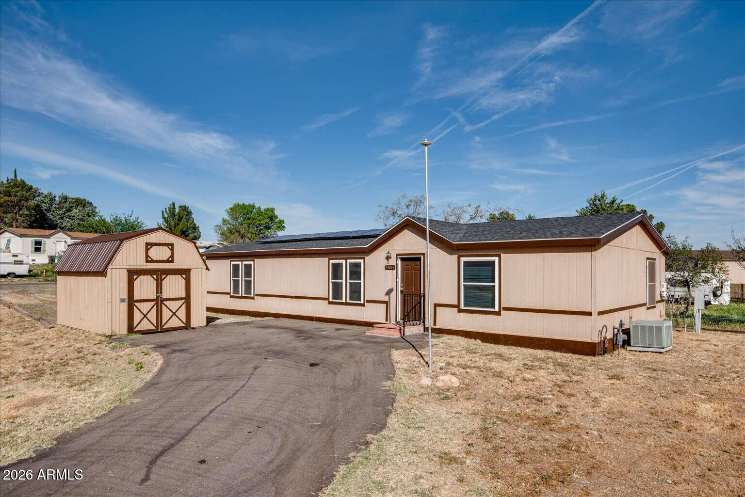 Situated on a spacious corner lot in Mayer, this well-maintained double wide offers comfortable living with thoughtful updates throughout. Enjoy new flooring and a fresh interior coat of paint, giving the home a clean, modern feel. The functional layout includes a dedicated laundry room for added convenience. Major improvements include a roof replaced in 2020 and solar panels for enhanced energy efficiency. Outside, a storage shed provides extra space for tools, equipment, or hobbies. With its prime corner location and practical features, this property is a great opportunity for full-time living or an investment.