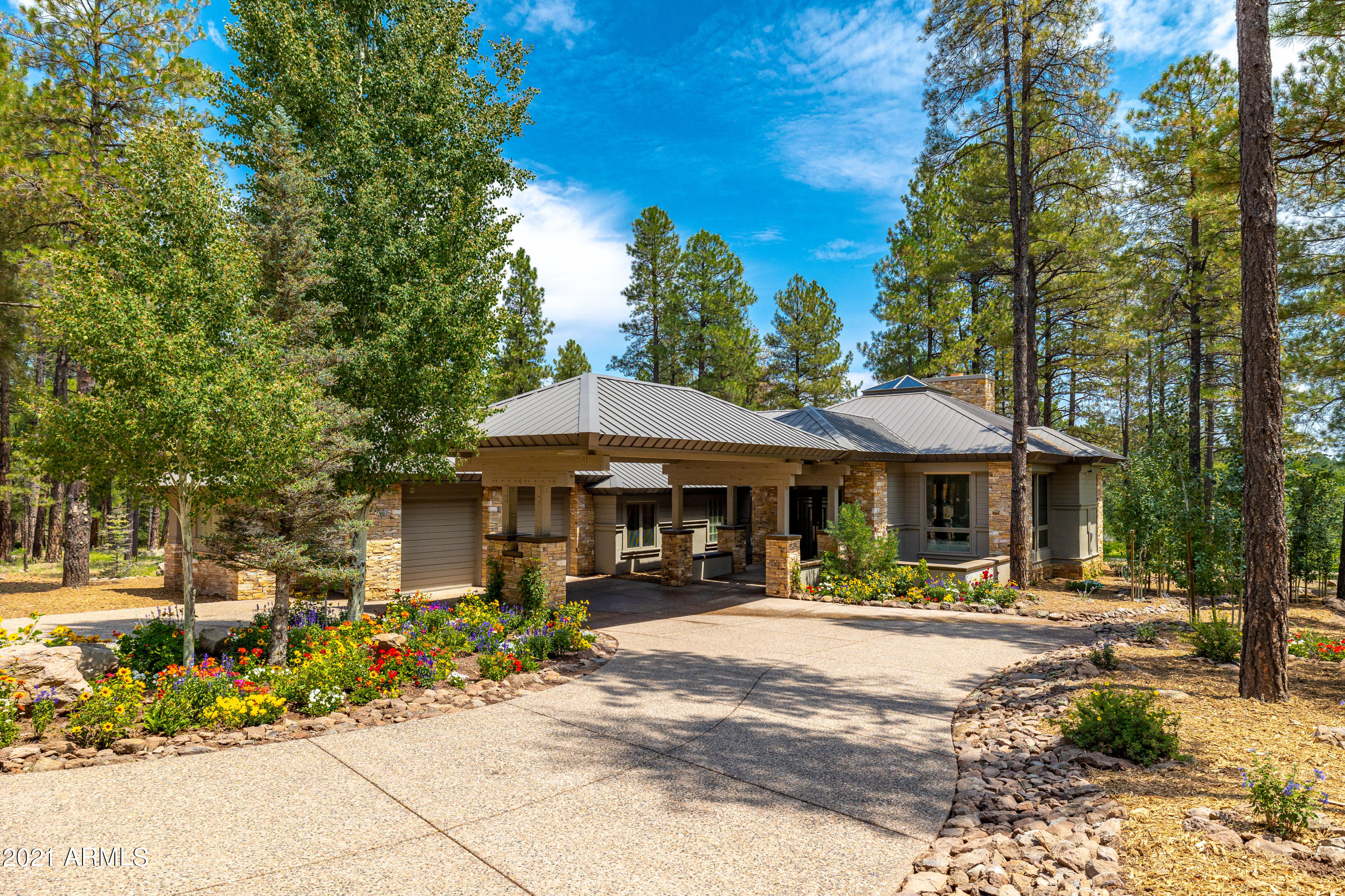 Be prepared to be in awe of this nearly completed Mountain Contemporary Masterpiece that takes style and sophistication to an entirely new level.  From the moment you start the drive down to this impeccable home you will begin to feel how special it is and take in the quality and craftsmanship that is found in every aspect inside and out of this unique single story home with no steps anywhere in the home!  The 2 story great room is set around the dramatic beamed ceiling complemented by a custom skylight to let the natural light in during the day and to take in the breathtaking stars in the evening.  Floor to ceiling windows and a 20 foot pocket door are yet another dramatic feature to let the outdoors in and enjoy the panoramic golf course and canyon views.  Entertaining is made a breeze