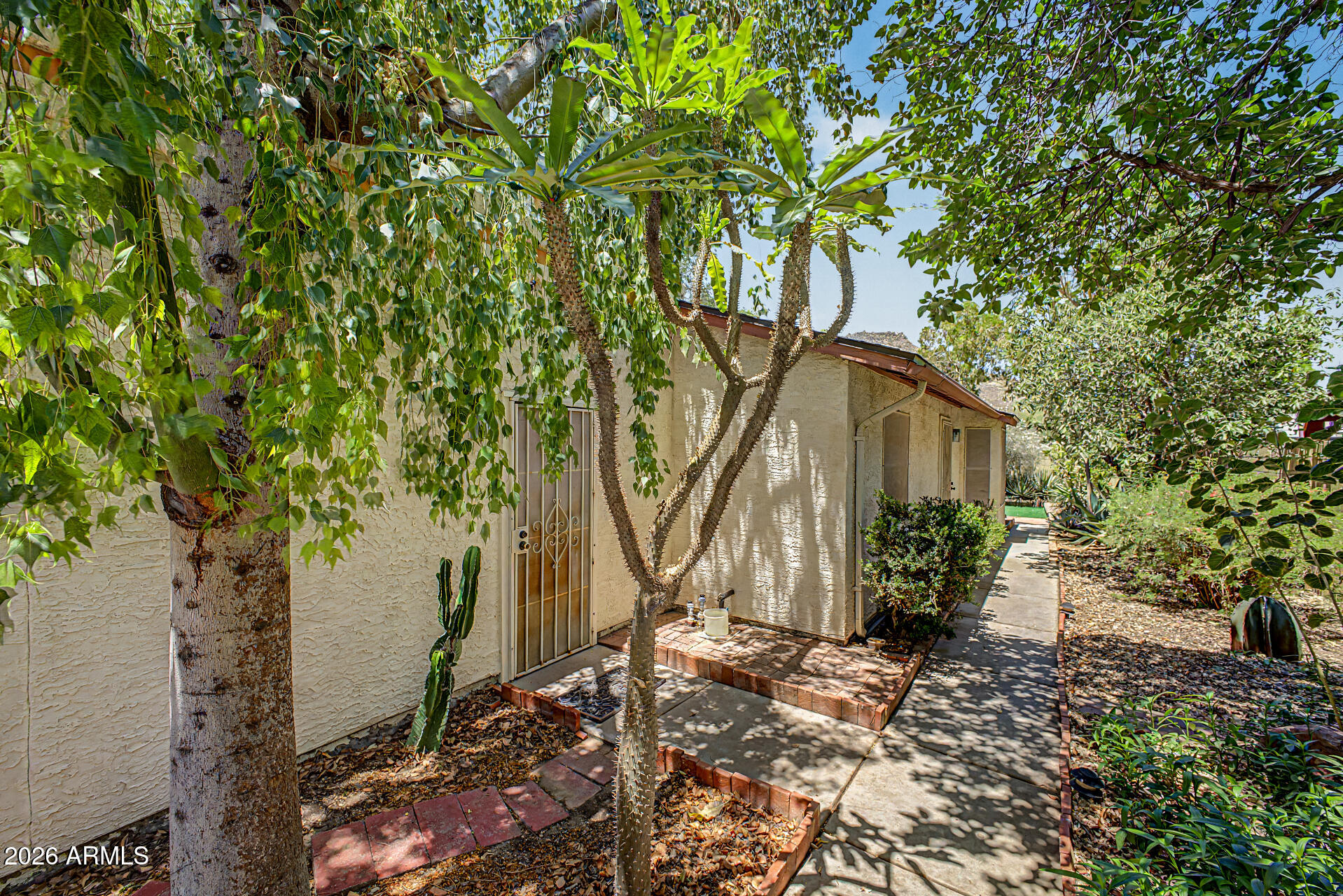 Tucked into a convenient North Glendale location, this charming 2 bedroom, 2 bath home offers comfort, efficiency, and thoughtful outdoor living in a manageable 884 square feet. Inside, engineered wood accent walls add visual warmth and extra insulation, while Milgard vinyl framed dual pane windows and a newer HVAC system installed in 2023 help improve energy efficiency year-round. The functional floor plan includes indoor laundry hookups and an attached insulated 2 car garage for added convenience. A lifetime termite protection plan with transferable warranty is also included for additional peace of mind. Step outside to a private fenced yard designed with mature shade trees that help keep utility costs lower while creating a peaceful retreat. There's even a dedicated area ready for your vegetable garden. Ideally located near the community pool, playground, and green space with easy freeway access for commuting, shopping, and dining. Great location for Honeywell Aerospace and Midwestern University!