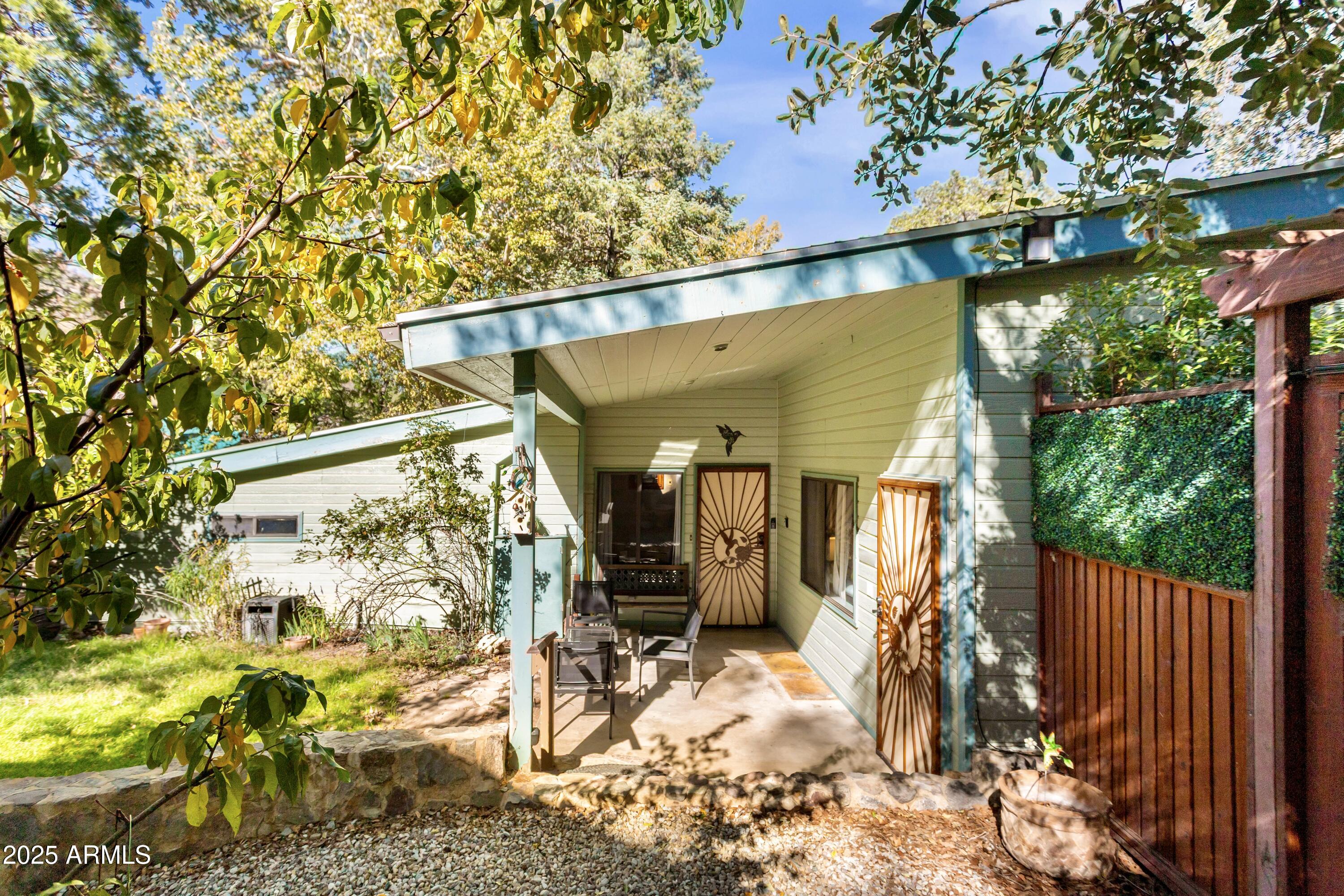 Sale includes parcel #105-46-005S (land only) and is a child listing to MLS # 6942021.

Over 5 acres, 2 homes, and room to develop!  This property features 2 homes and over 4 undeveloped acres with water access.  
The first is a single family style with 2 bedrooms, 1.5 baths, full kitchen, double stacked laundry units, covered patios, running pond complete with fish, private courtyards and more.  This place is plain good vibes, making you feel like your getting away from it all!  The original stone walls are not only beautiful but also impressive.  
The second structure is a triplex style. The first floor offers two suites.  Each suite has a condensed kitchen/dining area, living area, private bedroom with en suite bathroom. The second floor offer one expanded suite with full kitchen, dining and living room areas, private bedroom with large en suite bathroom.  The bathroom offers a tub/shower combo with a walk through closet.This property offers the flexibility of living in one structure and creating income in the second structure or generational living where everyone is in reach but still has privacy!  Great flexibility to customize to your needs!
Besides the amazing residences, this property also features 4 acres of land with water access that could be further developed.  Enjoy the bird blind towards the high end of the parcel to watch nature close up and personal!  The hummingbirds are breathtaking.  There is also an expansive paver patio area with a custom bar/gazebo.  This patio area is a retreat ensconsed in nature, features string lights that add a whimsy touch at night.  Don't forget the seasonal running creek!  It is a true delight!  Nature, wildlife, mature fruit trees and bushes cover this land. Take it all end!