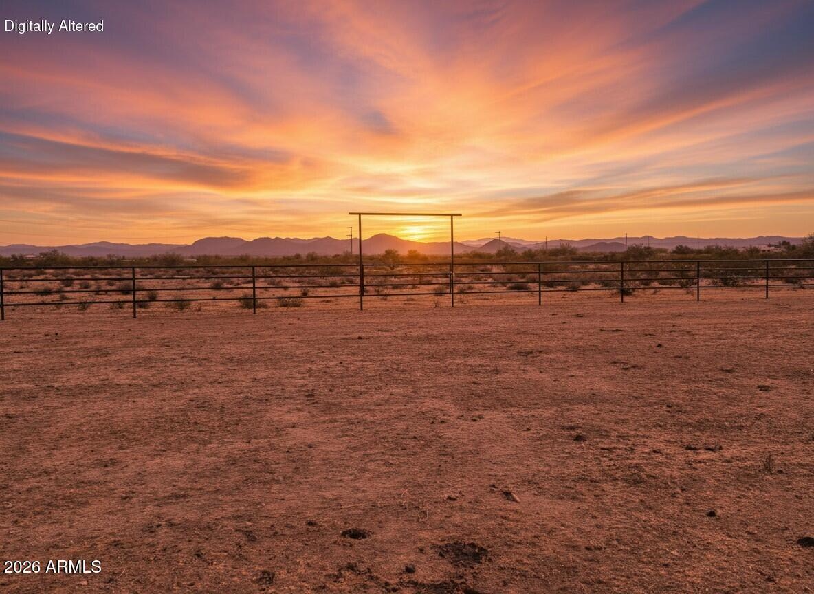 Spectacular 10 acre lot, pipe fenced on two sides!  Seller may FINANCE with negotiated  terms. Located in the prime roping neighborhood off N 211th Ave and Galvin Street.  Pride of ownership in this community is evident with land being restricted to site built homes and all underground utilities. Roping arenas and small ranches next to the property. Flat square parcel with just minimal flood plain on the east side this fully buildable parcel is also subdividable.  Power is at road frontage for easy connection when you build! Additionally this property is close to recreational areas, Lake Pleasant, Golf Courses, Shopping, and minutes away from the Team Roping Capital of the West in Wickenburg!