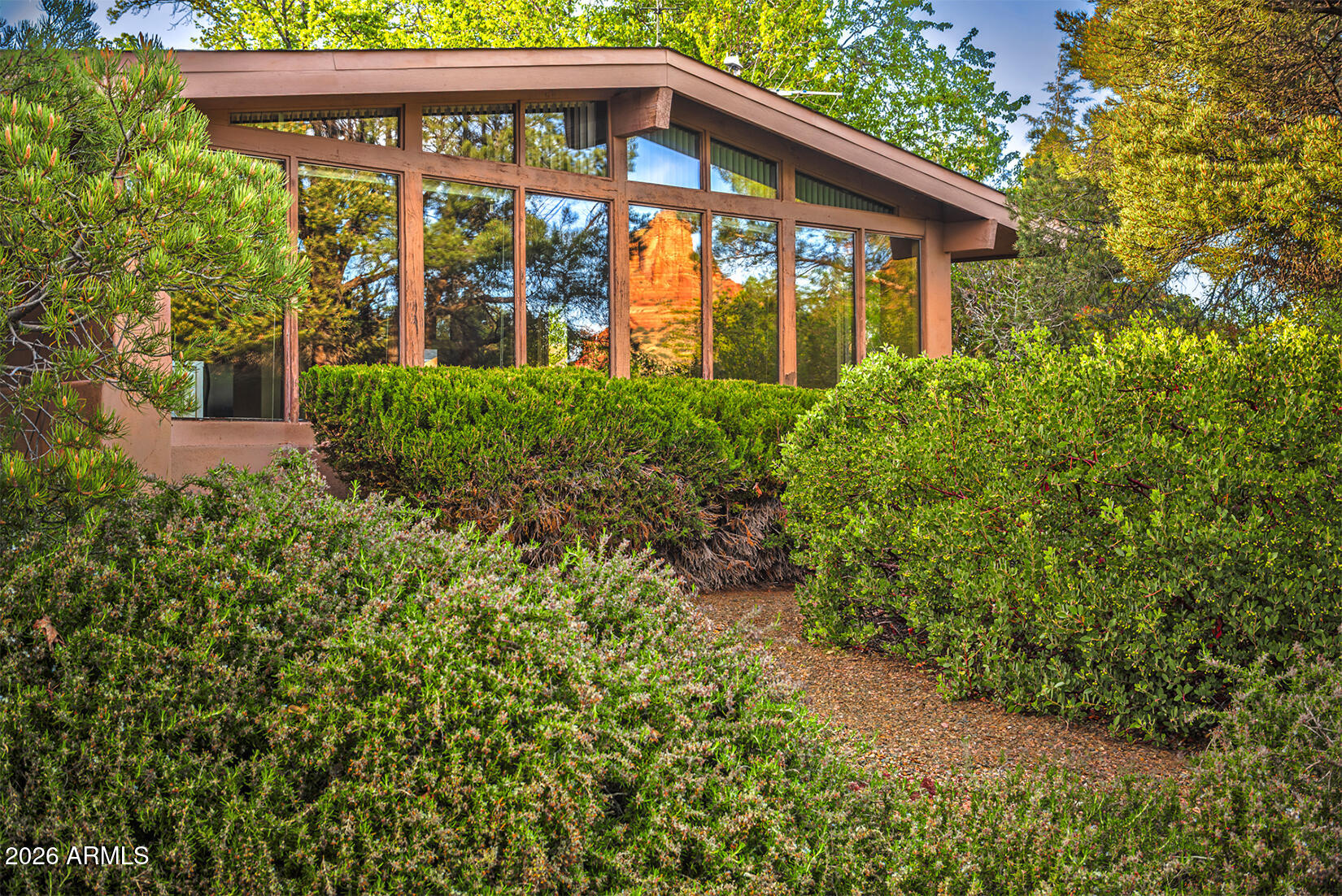 Nestled in a quiet cul-de-sac, the neighborhood exudes peace and solitude.  This cherished, single level Santa Fe Spanish-style home feels like a warm embrace the moment you walk in. Soaring vaulted ceilings with gorgeous tongue-and-groove wood and hand-hewn beams set the tone, cozy, character-filled, and inviting.  3 bedrooms, 2 baths and 2065 SF of thoughtfully designed living on .23 acre lot give you room to breathe and room to dream. Solar panels keep everyday living simple and sustainable, and with trail access right outside your door, Sedona's breathtaking beauty is just steps away.   This is the one you'll feel in your heart before you finish the tour.  Beautiful bones, location unbeatable, and with a little TLC this one will shine.  STR permitted, please verify.