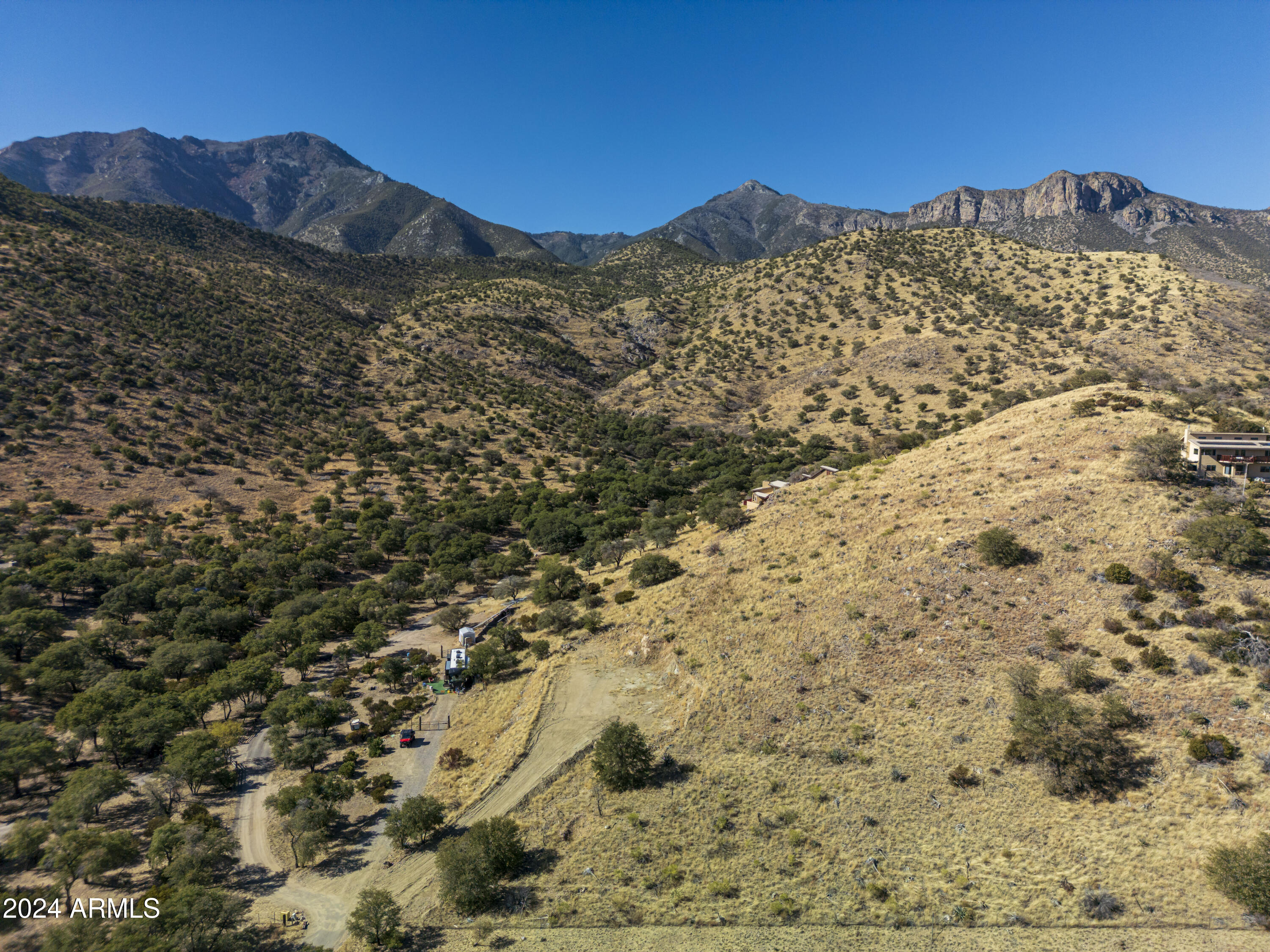 Once in a lifetime place to build your dream home or invest in a truly unique property? This is exactly what you've been waiting for. Nestled in a peaceful and picturesque setting, the land offers not only natural beauty but also the practical features you need to make your vision a reality. Imagine two wells on the property: one capped and uncased, and the other solar-powered, feeding a 1,500-gallon underground holding tank with a brand-new pump and tank. The septic system is also newly installed, featuring a 1,000-gallon tank and a fully permitted mound system. It's all set up and ready to support your future home. The property is fully equipped with a solar system that provides power for the existing RV site on the lower portion of the land. With 10kW of battery
