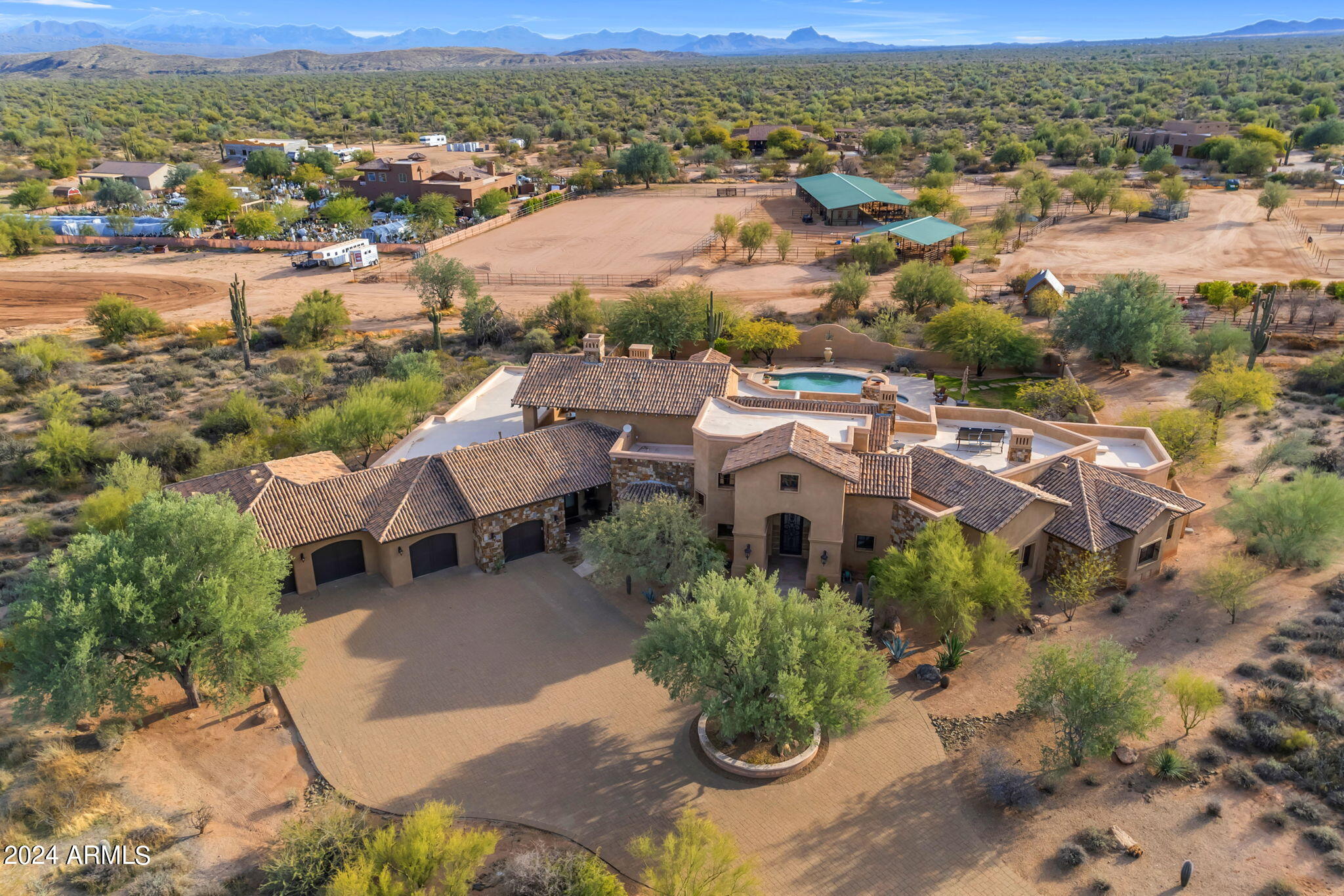 Equestrians paradise on 14 acres! This Tuscan-inspired luxury home, created by the prestigious builder Paul Levato, spans over 6,600 square feet showcasing intricate details, vaulted ceilings, and high-end finishes. The expansive kitchen is a chef's dream, equipped with state-of-the-art appliances, a large center island and bar top counter space for entertaining. The remarkable outdoor entertaining space includes a giant covered patio, a grand outdoor fireplace and mesmerizing views that provide the perfect backdrop for enjoying Arizona's breathtaking sunsets. The horse facility is designed with precision, featuring a 10 stall breezeway barn with oversized stalls that each open up to large turnouts, automatic waterers, a spacious tack room and plenty o space for a farriers bay or saddling area. Adding to the equestrian amenities,  is a huge 140 x 260 riding arena and four giant 70x280 turn outs with water and shades.  The property's 14 acres offer a mix of lush landscapes, desert flora, and open spaces, creating a serene and private retreat and easy access to the open in desert in The McDowell Mountain Park for unlimited trail riding, hiking and biking. Conveniently located in the Rio Verde foothills, you and your family can enjoy the tranquility of rural living while still being within reach of urban amenities. This unique property represents the epitome of luxury living combined with a passion for horses and the great outdoors.