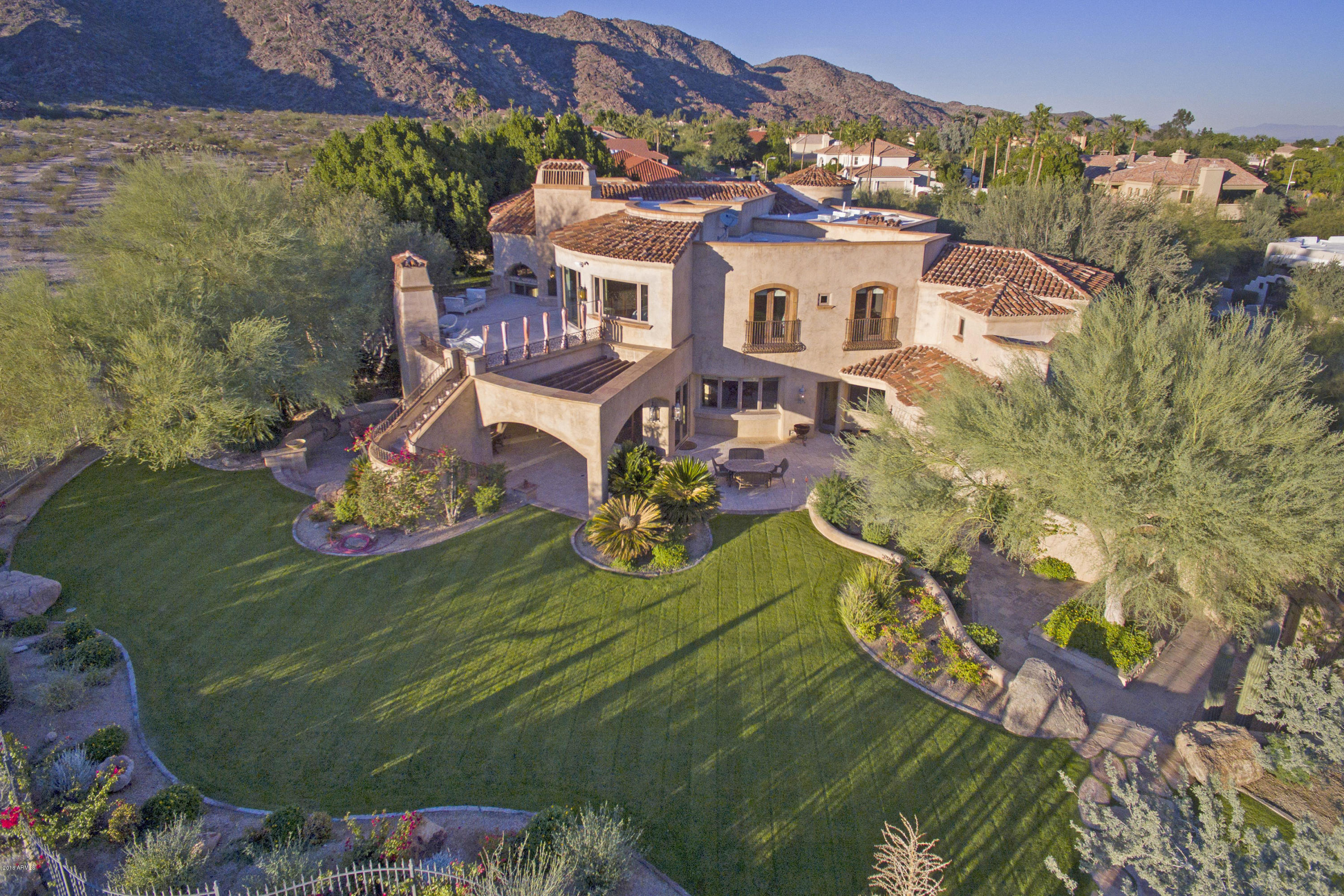 Featured Wall Street Journal ''House of the Day'' -an Entertainers Paradise- A one of a kind design by renowned architect David Dick, Kitchell built luxury estate combines 14,127 sq ft main & 1278 sq ft guest house. A private lifestyle property that exudes feelings of comfort, class & ''home'' in every uniquely appointed room.  Acre parcel w/ mature botanical arboretum Berghoff gardens stages unobstructed views of the adjoining 16,000+ acres offering 51 miles of trails on S. Mountain Park, one of the largest municipal parks in USA, bringing nature's inspiring tranquility,  dramatic sunrises & breathtaking sunsets seen from multiple verandas, patios & trails. Nestled directly on South Mountain Park Preserve. VOTED BEST HOME ON AHWATUKEE LUXURY TOUR!! One must tour. To fully appreciate the special blend of uncompromising craftsmanship; the old world specialty custom Venetian exterior stucco (plaster) was commissioned by the only specialist in Arizona and applied identical to the old world masters of Italy, custom ironwork throughout stairs, railings and the exterior including Romeo and Juliet balcony's off the master suite. Stunning architecture showcases views from all the windows and verandas framing the natural beauty of the Southwest. 

Enhancements made by current ownership includes upgraded Snaplink System that controls 12 separate HVAC zones to be compatible with mobile devices controlling lighting, alarms, and surveillance systems. 

Several details make this home extraordinary: 

A Double Lot - like none other in the Equestrian Trails subdivision. Plenty of space and amenities for entertaining corporate or familial gatherings and guests; complete with Board Room/Study Room or several entertaining spaces with ample conveniences on property: 3 ice makers and 3 dishwashers located in the Kitchen, Bar and Media areas. An open air basement and 3rd level where the Media/Game Room in basement boasts full controlled wine cellar, multiple True' fridges and coolers, along with storage and workout room.

Owners took care and replaced and upgraded fixtures throughout; including Luxury Steam Dual Shower with Grohe Fixtures in Master Suite bathroom, this spacious suite incorporates a full living room with fireplace and mini kitchen complete with Sink, Fridge and Microwave and sweeping Preserve views and veranda.

Two (2) full laundry rooms in main house and complete laundry room in guest house along with full guest house kitchen, in the 1200+ Sq foot separate and detached guest home.

Owners installed two custom fountains, custom wood flooring, dumb waiter, private custom dance studio in Guest Home and more.

Designs are complete by Creative Environments luxury landscape designers for a stunning Lap Pool with water feature. Luminescent lap pool tile material already purchased and in storage for this project.  Pool design extends from home's wrap-around patio out to connect to existing pool complete with stone, fountain design and bridge element. (design concept renderings available).

Come see the endless list of quality and beauty that will make Honah Lee Court your reason to call this estate your home

Owner is looking forward to reviewing your offer. Now is your opportunity! 

Call the natural peace and privacy of South Mountain preserve your very own personal paradise.

Shown by appointment.