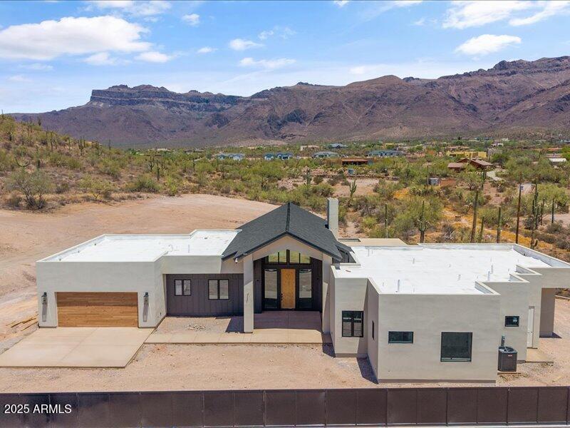 Where Desert Meets Distinction  - Welcome to Kings Ranch Ct. Set against the awe-inspiring backdrop of the Superstition Mountains, Kings Court Ranch is where timeless craftsmanship and desert elegance come together. At the heart of the home, the stunning gourmet kitchen is designed to impress with double islands, premium appliances, and ample space to gather making entertaining effortless. The centerpiece of the living area is a striking fireplace, blending modern design with rustic warmth to perfectly reflect the surrounding desert landscape. The home features 2x6 construction, 5/8'' drywall, and advanced foam insulation for enhanced soundproofing and energy efficiency. A robust 400 Amp electrical service and 20 Amp outlets at every location ensure your home is built for modern living at Kings Court Ranch, every detail is designed to elevate your lifestyle - where desert beauty meets custom luxury, and the Superstitions are your everyday view.