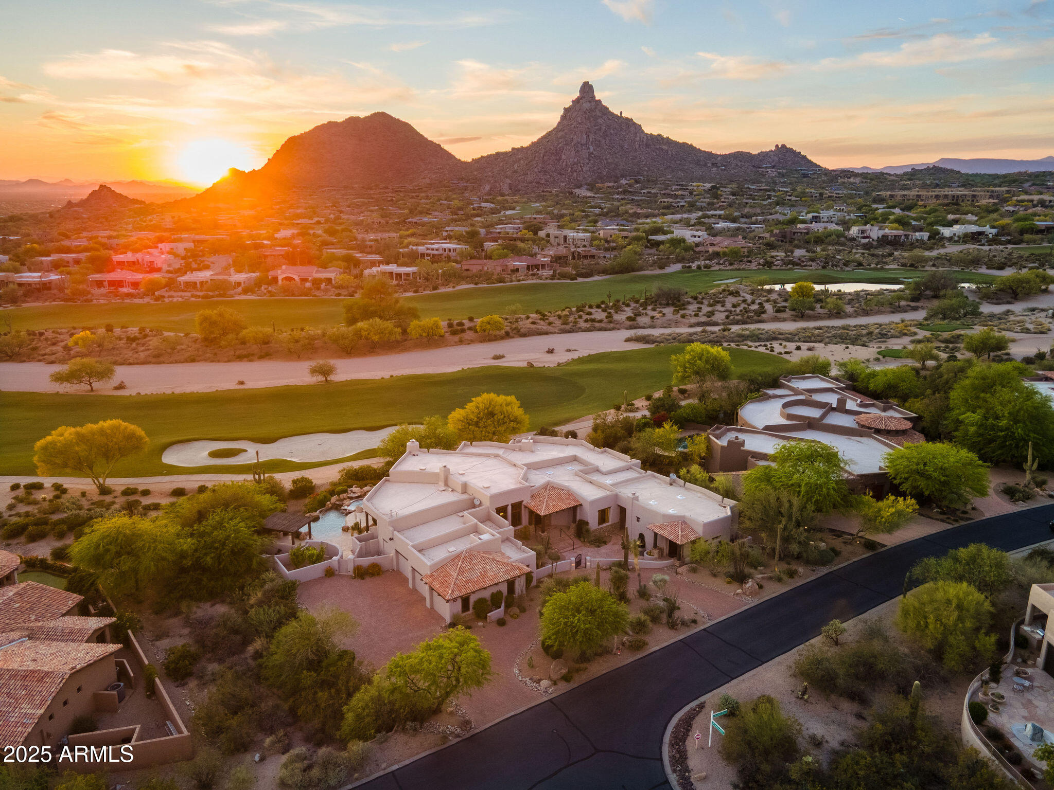 Embracing the new, honoring the past - a rare opportunity to own one of North Scottsdale's most captivating home transformations, where modern design meets the enduring charm of Arizona's architectural legacy. Perfectly positioned on the 8th fairway of Troon's premier golf course, this reimagined residence with guest house offers seamless indoor/outdoor luxury living in the coveted guard-gated community of Windy Walk Estates.  Enjoy one of the finest lot locations with unobstructed views of Pinnacle Peak, city lights, and vibrant sunsets all beautifully framed through expansive windows and reflected in the home's meticulous craftsmanship.