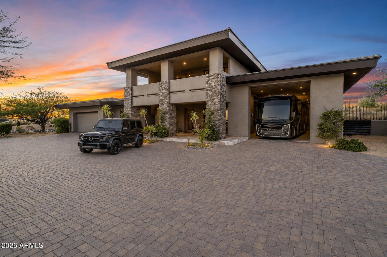Set against a stunning 4.3-acre North Scottsdale backdrop, NO HOA masterclass desert luxury living, framed by panoramic mountain vistas and glittering city light views, for an avid collector. The 6,800-square-foot main residence is designed for both grand-scale entertaining and refined all-in-one level daily living, featuring a magnificent great room, a professional chef's kitchen with a wet bar, and a dedicated (second-level) media/billiard room. The home is thoughtfully tailored for the modern professional with dual executive offices, while the primary sanctuary offers a fireplace, coffee station, and a decadent, spa-inspired bath. The grounds are a paradise for the collector and the host alike, headlined by a massive 12-car / RV garage and GATED motor court. The outdoor oasis features oversized patios, an alfresco kitchen, a heated pool and spa positioned to capture the sunset. Completing this desert compound are TWO detached, fully equipped guest HOMES with private kitchenettes, situated across a charming front courtyard to ensure ultimate privacy for visitors. This is a rare opportunity to own a sophisticated retreat that balances immense scale with intimate, high-end detail.