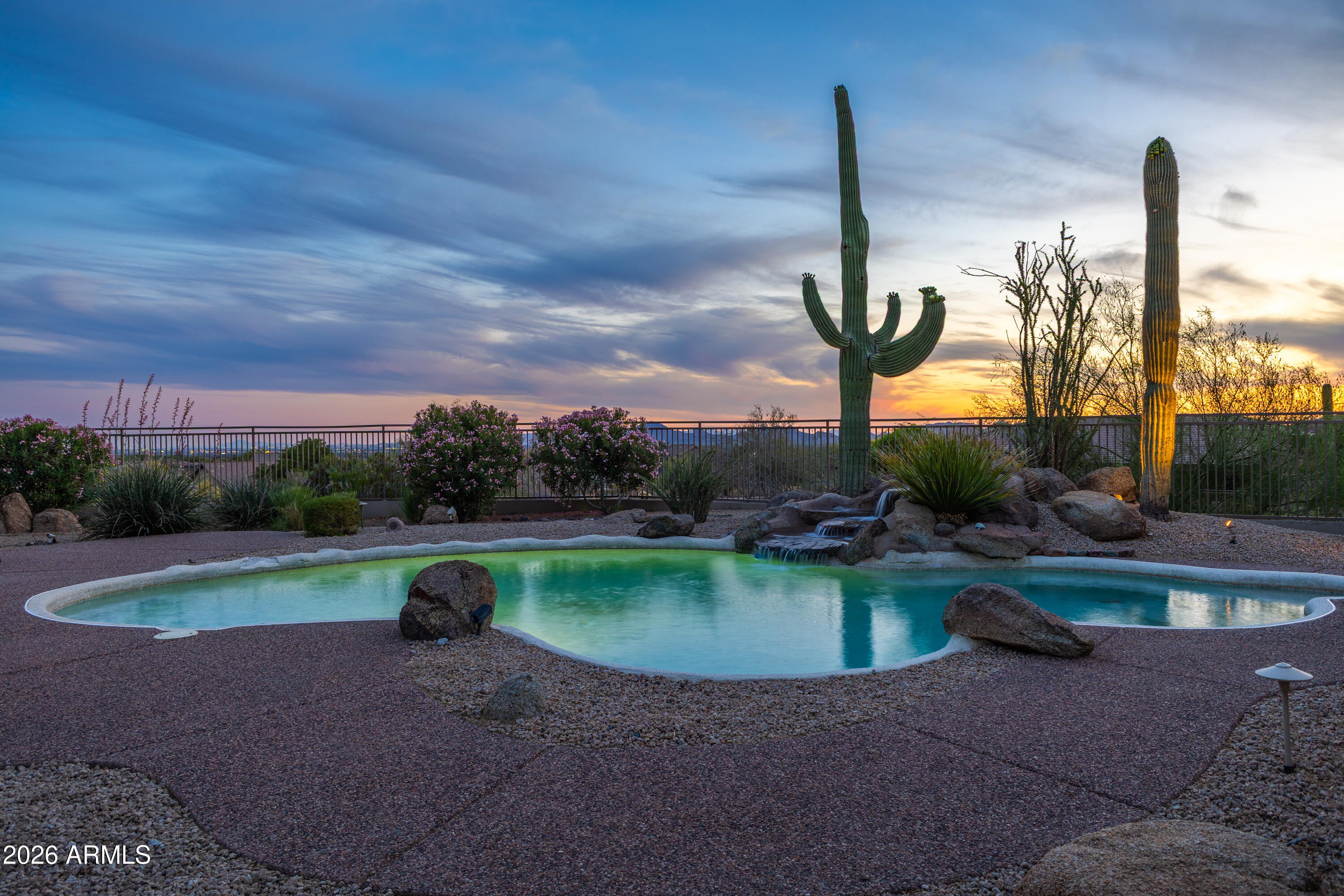 PANORAMIC VIEWS FROM A PREMIUM CORNER LOT IN McDOWELL MOUNTAIN RANCH! Pristinely situated on an elevated cul-de-sac lot backing to a natural wash, this exceptional property offers the ultimate Arizona lifestyle with an entertainer's backyard featuring a built-in BBQ bar, pool, spa, and breathtaking mountain views.
This 4-bedroom, 3-bath home (plus loft-style bonus room), welcomes you with soaring ceilings, designer lighting and finishes, and real hardwood flooring throughout. The open-concept kitchen features custom cabinetry, quartz countertops, and high-end appliances. The main-level primary suite includes direct patio access, a modern walk-in shower, separate soaking tub, generous walk-in closet, and panoramic views. Fully owned solar panels provide energy-efficient low-cost living.