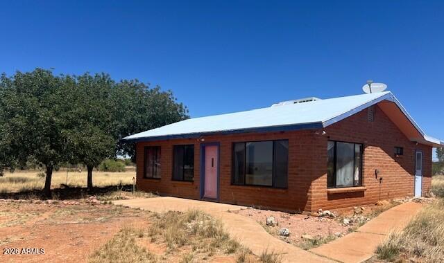 Nestled in the highly sought-after Sonoita area, this one-of-a-kind property offers breathtaking 360-degree mountain views across 7.5 peaceful acres. Surrounded by the scenic beauty of Arizona wine country, this unique setup combines privacy, flexibility & endless potential. The main home features two spacious bedroom suites, each with its own private bathroom, separate entrance & dedicated living room area - ideal for multi-generational living, guests, or rental opportunities. A second detached building includes the kitchen, laundry area & a versatile bonus space that can serve as a small apartment, studio, office, or additional storage.  Enjoy wide-open skies, stunning sunrises and sunsets & the tranquility of country living while being conveniently close to the charming town of Sonoita!