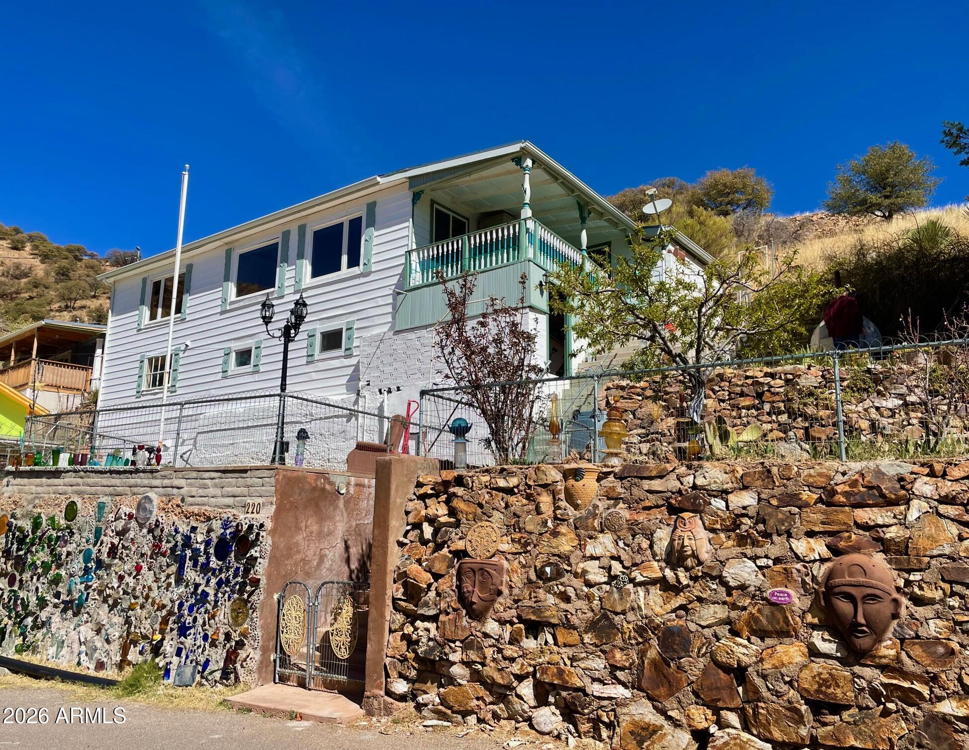 NEW REDUCED PRICE! Beautiful and spacious 3-bedroom, 2-bath home with captivating views in the heart of Old Bisbee. Perched in the desirable Opera Dr. neighborhood, this home has so much to offer: spacious bedrooms and open concept living areas all on one sun-drenched level, new interior paint, whole house water filter, all electric utilities, daylight basement with 3 rooms, French door from primary bedroom opening on to a bricked patio. Outside, one finds a sociable balcony providing far-reaching views, multiple fenced and terraced yards including another large patio, fruit orchard, pizza oven, and space! Motivated Seller! Buyer to verify all facts/figures.
