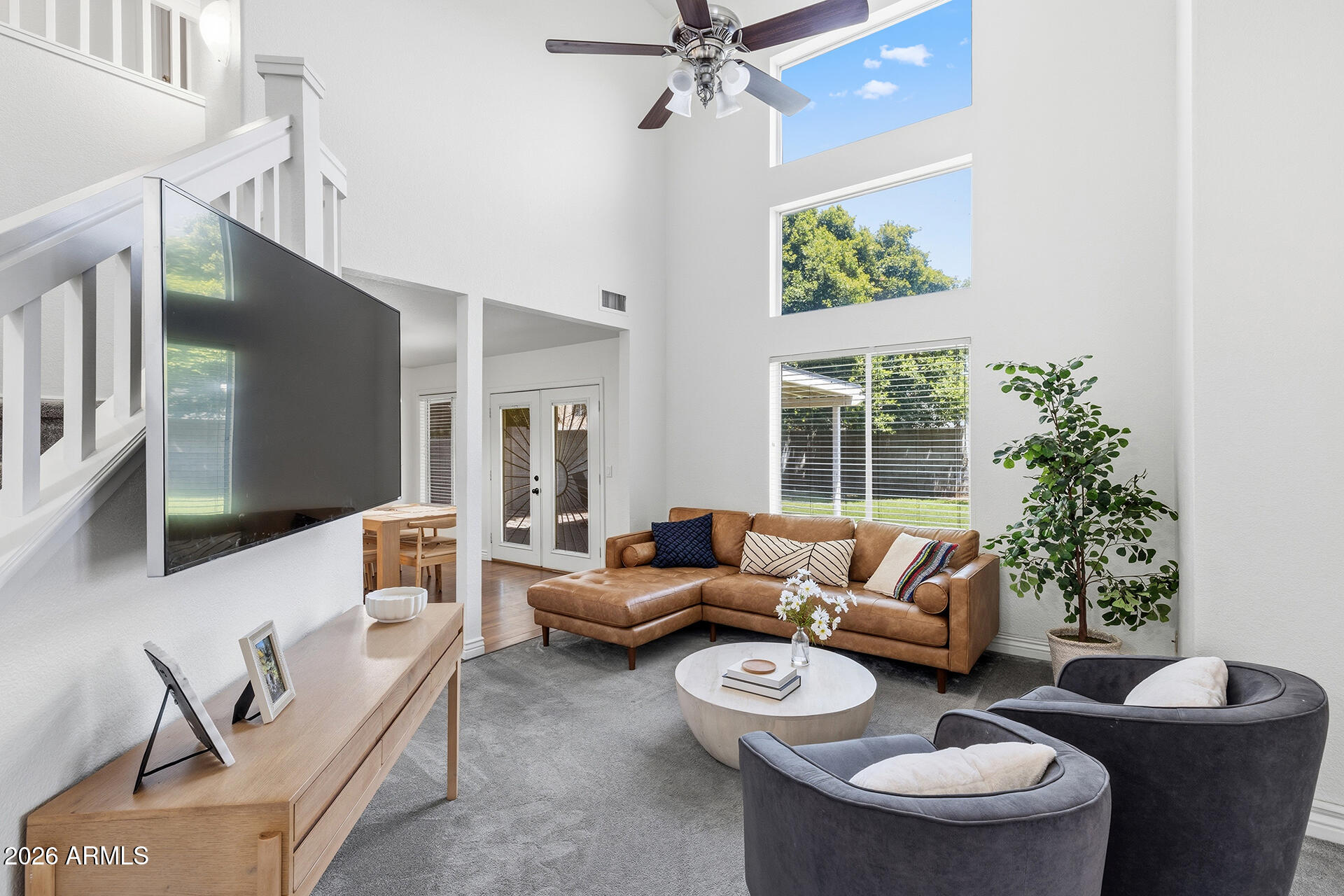 Remodeled & Gorgeous! Nestled in the desirable Copper Ranch community, this move-in ready home showcases soaring vaulted ceilings, a dramatic staircase, engineered wood floors & a stunning wall of windows that fills the living room with natural light. The beautifully updated kitchen features cabinetry with abundant storage, granite countertops, an updated tile backsplash, breakfast bar seating, a built-in work desk, and appliances replaced within the past three years. The adjacent dining area opens seamlessly to the backyard through French doors, creating an ideal space for everyday living & entertaining. Fresh interior paint & new carpet add to the home's appeal. Upstairs, the spacious primary suite offers vaulted ceilings, a walk-in closet, and a private ensuite with dual vanities & a walk-in shower. The secondary bedrooms are generously sized and share a full bathroom. Step outside to enjoy the large, covered patio, grassy yard & block fencing, offering plenty of space to relax, or entertain. Residents of Copper Ranch have access to walking paths, green spaces, and basketball courts, all conveniently located near Downtown Gilbert & Gilbert Commons, plus access to AZ-60, Loop 101 & additional shopping, dining & recreation!