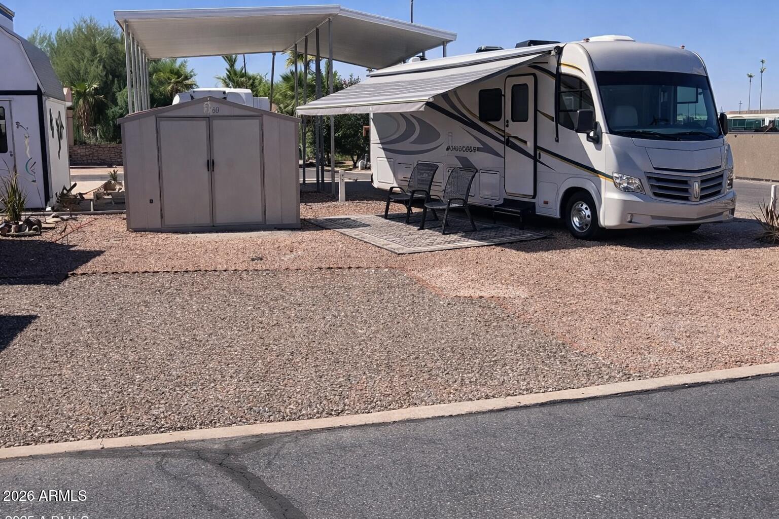 401 E Pueblo Del Sol, this North/South facing corner lot measures 34 by 48 feet and offers flexible use for RV parking or a park model home. With full land ownership, you'll enjoy the freedom of no lot rent and a low annual HOA fee that grants access to the resort-style amenities in this 55+ community. Tierra Del Sol features a heated pool and spa, pickleball courts, a clubhouse for community events, and on-site conveniences like laundry and storage. This lot allows for covered parking and patio space, ideal for creating a shaded outdoor living area. Whether you're seeking a seasonal home base or full-time comfort, this site supports both. Enjoy a connected lifestyle in a walkable and social setting just minutes from downtown Florence.