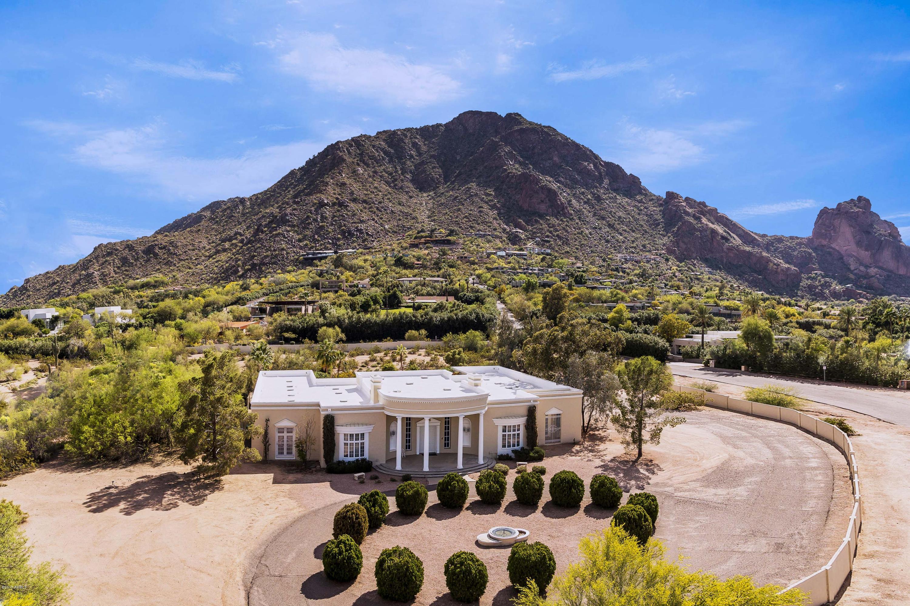 On 3.23 acres, with spectacular close full Camelback Mountain views, rests a 3 bedroom palatial 7,470 sf home on one of the most prestigious streets in P.V. Endless potential to remodel, built in 1979, with large rooms, impressive wide main hallway, elegant carved crown moulding, handsome paneled library with fireplace, beautiful formal living and dining rooms, charming family room  and large open and bright morning room adjoining the large kitchen. The home  is of block construction. There is a large partially unfinished lower level.