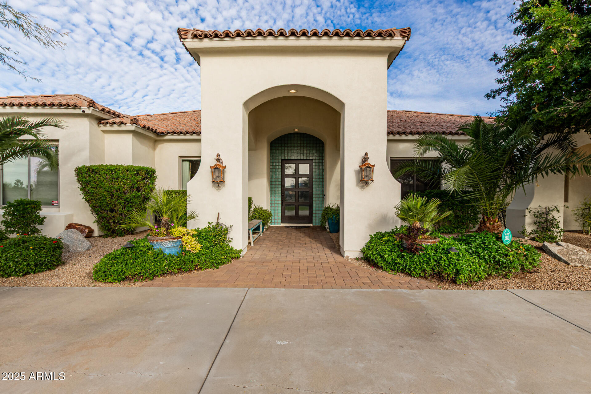 Plenty of room for the whole family! This Santa Barbara-style estate offers tons of space and charm - conveniently located just minutes to Old Town or Kierland/ SQ. Situated on a prime corner lot, this 7-bedroom, 6-bath, 6,945 sq ft residence features arched doorways, soaring ceilings, and rich traditional details throughout. Designed with multiple living areas, wet bars, and an in-home theater, this residence comfortably accommodates a large family or multi-generational living. The expanded primary suite is a true retreat with dual wings - one offers a custom walk-in closet with washer/dryer, soaking tub, dual vanities, and a private bidet room. The other wing includes a massive steam shower, bidet, wet bar, walk-in closet, and a private office/lounge with direct backyard access. The open-concept main living room with fireplace flows into a charming breakfast nook and formal dining room with exposed beams, while the chef's kitchen offers a Sub-Zero refrigerator, double ovens, gas cooktop and pot filler.  Outside you will find a resort-style backyard oasis, complete with a diving pool, fire pit, Alfa pizza oven, outdoor kitchen, above-ground spa, lush landscaping, synthetic turf, multiple covered patios, and a ½ basketball court perfect for entertaining year-round. Ideally located near freeways, premier shopping, dining, this exceptional estate offers the perfect blend of space, privacy, and sophistication.