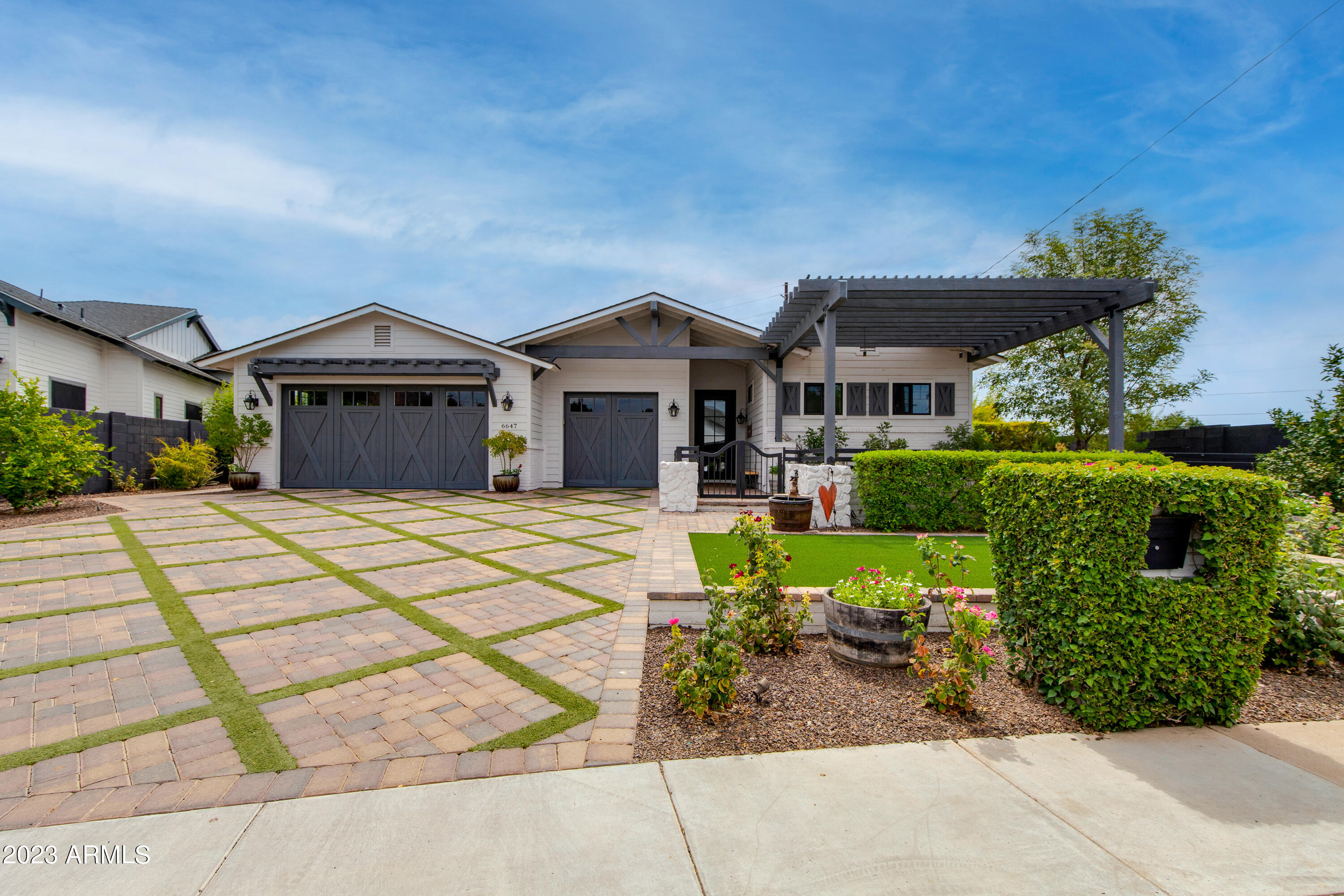 This stunning Modern Arcadia Farmhouse is minutes from Old Town and Fashion Square in the coveted Hopi School District. This entertainer's dream features 4 beds + den, 3.5 baths, a temperature controlled 3 car garage and a resort style backyard with a sparkling pool, lush landscaping, 2 water features, 2 fire pits, and a separate dog run. Inside you will find hardwood floors throughout, an open concept chef's kitchen with Wolf/Sub Zero Appliances, a walk-in bar and beautiful Caesarstone and Carrera marble countertops. The spacious split primary suite is filled with natural light from the sliding glass wall overlooking the pool and features a sizable walk-in Classy Closet. The bonus den is the perfect teen/media room, or could easily be converted into a 5th bedroom. Welcome Home!