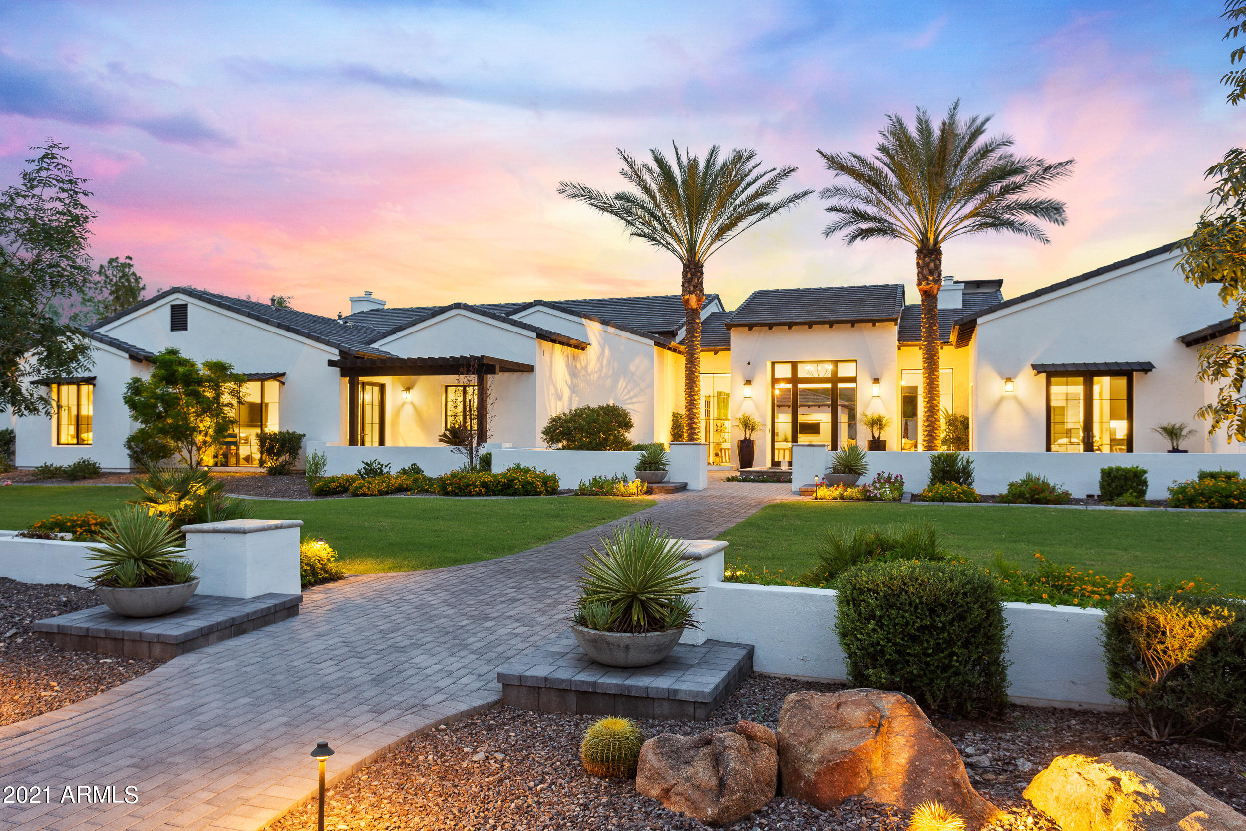 Immerse yourself in this Paradise Valley masterpiece. This modern style estate is a luxurious oasis characterized by state-of-the-art amenities, transitional designs and a split open floor plan. Luxury takes on a new meaning with exquisite architectural details including soaring ceilings, retractable glass, and an extravagant outdoor space. Marvel at the beauty of the resort style pool, spa, water features, multiple fire features and complete outdoor kitchen. Sophisticated owner's retreat offers sitting area, 2 large walk-In closets, 2 water closets & steam shower.  Enjoy the mountain views and gorgeous exposed beams from the large family room & kitchen. This Single Level floorpan offers world class amenities; game room,media/theater Room, wine room, office and more on 1+ acre.