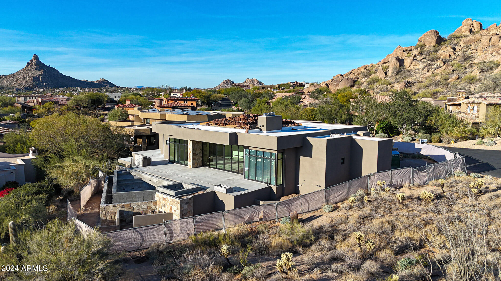 Coming soon! This stunning new build, set for completion in Q1 of 2025, offers luxurious living in the exclusive guard-gated community of Artesano on the Southwest slope of Troon Mountain. Thoughtfully designed with a split floor plan, the main level features a spacious primary suite and two guest suites, all with ensuite bathrooms and exterior exits to the back patio. The great room showcases wood ceiling treatments and a gas fireplace, while the kitchen is equipped with top-tier appliances, including two ovens, two dishwashers, two sinks, and a wine column situated between the fridge and freezer. Additional highlights include a breakfast nook, private study, formal dining room with a wine display, powder bath, and a large laundry/smart space. The lower level includes another guest suite and a bonus room, perfect for in-law quarters or additional living space. Low voltage wiring can be found throughout. The home features a four-car garage along with a half-circle driveway. Outside, the expansive patio is complemented by a negative edge heated pool, spa, and a cozy firepit, offering the perfect space to relax while enjoying stunning city light and mountain views.

This home is ideally situated on a private cul-de-sac, with views of Troon Mountain from the front of the property and just a short walk to Troon Country Club. The builder is open to buyer customization and finish selections, allowing you to make this exceptional property your own.