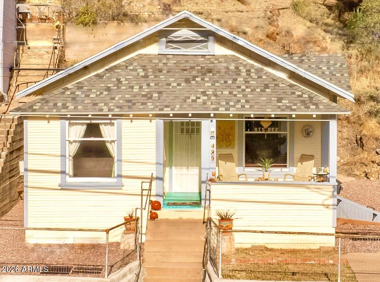 A remarkable Old Bisbee Bungalow in excellent condition. New Roof in 2021, new windows, a comfortable front porch. Step inside to a living room with beautiful hardwood flooring with dining area and pass through window to the kitchen. Laundry with stack washer/dryer plus a laundry sink. 2 bedrooms, 1 full bath with a combination tub shower and pedestal sink. A small car garage or good storage area. Good neighborhood on bus line. Excellent second home or retirement property.  Soil remediation has been completed, also upgraded electrical.