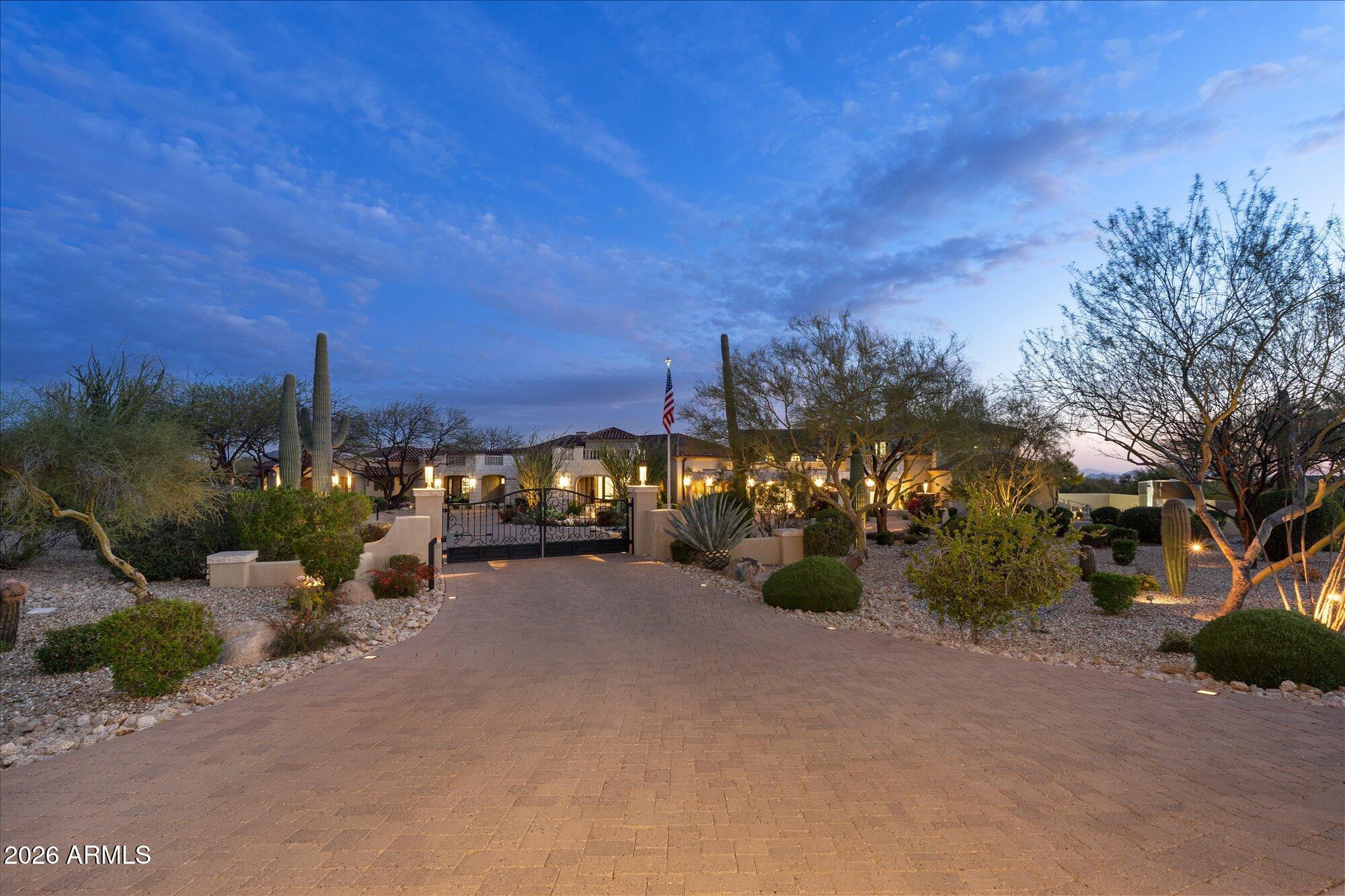 3.7-acre estate inside the Gated subdivision of MERIT CROSSING with stunning views of Pinnacle Peak, near Estancia and Troon North. Reimagined in 2017; the gourmet kitchen now offers an oversized entertainment island with a river sink and under-lit quartz countertop; oversized pantry with a library ladder and a food prep area along with double ovens, theater, exercise room, 2 gorgeous master suites and fixtures. Incredible views of near and far mountains plus sparkling city lights! The backyard has a large covered entertainment area with misters, heaters, Audio and Video plus a fireplace. Full outdoor BBQ area, 2 Pergola's, multiple fire and water features, artificial turf, fruit trees and sauna. Automated screens on large multi-slide doors. SEE MOTION VIDEO...