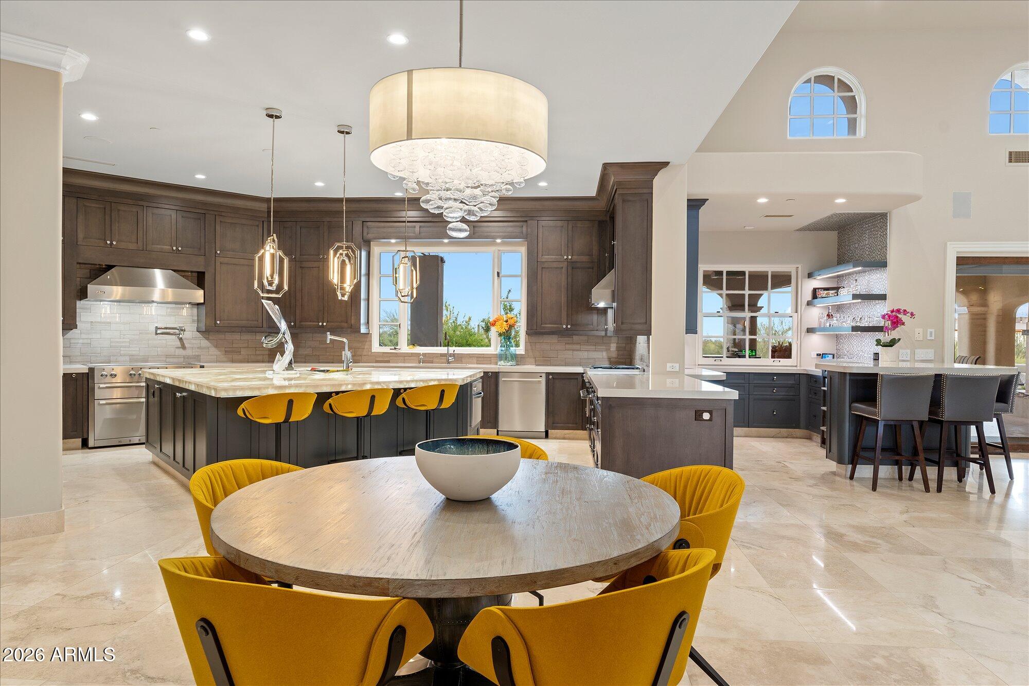 3.7-acre estate inside the Gated subdivision of MERIT CROSSING with stunning views of Pinnacle Peak, near Estancia and Troon North. Reimagined in 2017; the gourmet kitchen now offers an oversized entertainment island with a river sink and under-lit quartz countertop; oversized pantry with a library ladder and a food prep area along with double ovens, theater, exercise room, 2 gorgeous master suites and fixtures. Incredible views of near and far mountains plus sparkling city lights! The backyard has a large covered entertainment area with misters, heaters, Audio and Video plus a fireplace. Full outdoor BBQ area, 2 Pergola's, multiple fire and water features, artificial turf, fruit trees and sauna. Automated screens on large multi-slide doors. SEE MOTION VIDEO...