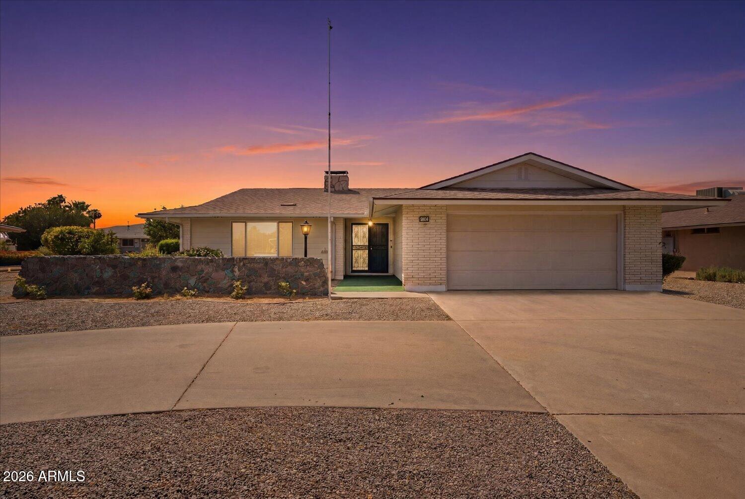 Welcome to this beautifully maintained Sun City home offering comfort, space, & numerous updates throughout. Inside, you'll find updated flooring, a spacious layout, & a stunning floor-to-ceiling wood-burning stone fireplace that creates a warm & inviting focal point. The kitchen features ample cabinet & counter space, a breakfast bar, & all appliances convey, including the refrigerator, washer, & dryer. Recent improvements include new windows & sliding glass doors, a new sewer line, new insulation, a remodeled primary shower, a new water heater in 2025, & a roof replaced in 2014. Enjoy Arizona's beautiful weather year-round from the screened-in porch, perfect for relaxing or entertaining. Located in the highly sought-after Sun City active adult community, residents enjoy access to recreation centers, golf courses, swimming pools, fitness centers, pickleball, clubs, and countless social activities. This move-in ready home offers the perfect opportunity to enjoy the Sun City lifestyle.