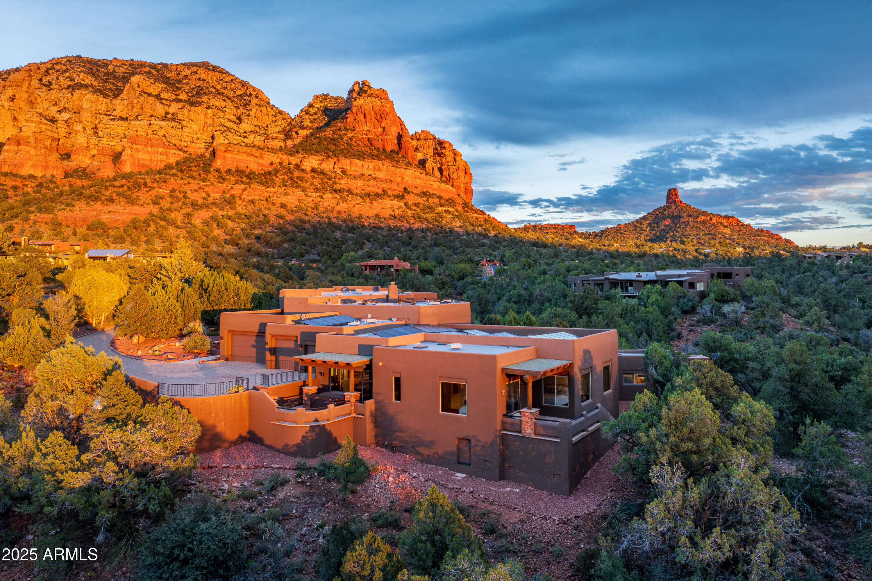 LUXURY LIVING IN HIGHLY SOUGHT AFTER NEIGHBORHOOD-- THE ESTATES AT NORTH SLOPES--Privacy, Sustainability, and Stunning Views—all just minutes from the heart of Sedona. Perfectly positioned on 3 acres this Southwest Contemporary design offers breathtaking Red Rock vistas and a serene, upscale lifestyle with easy access to world-class amenities. The Exclusive World Renown Seven Canyons Golf Club and Enchantment Resort are only minutes away. Meticulously maintained and thoughtfully upgraded, this residence features:Top-of-the-line Wolf and Sub-Zero appliances;Sonos Surround Sound System for premium audio;Stucco exterior for low maintenance and durability;New TPO membrane roof;Solar system with battery storage and backup generator, ensuring uninterrupted, energy efficient living. Energy Security: Off Grid Capability - This home can operate independently during power outages, blackouts, or infrastructure failures, ensuring continued access to essential resources. 
Whether you're seeking a full-time residence or a luxury escape, this home blends refined living with modern self-sufficiency in one of Sedona's most coveted communities.
This architectural design of this home offers 5306 sqft of luxury living in the main house and an additional 397 sqft in the well placed casita. The 1200 sqft garage provides room for three full size vehicles, a golf cart, work benches and storage galore for all of your hobbies and toys.