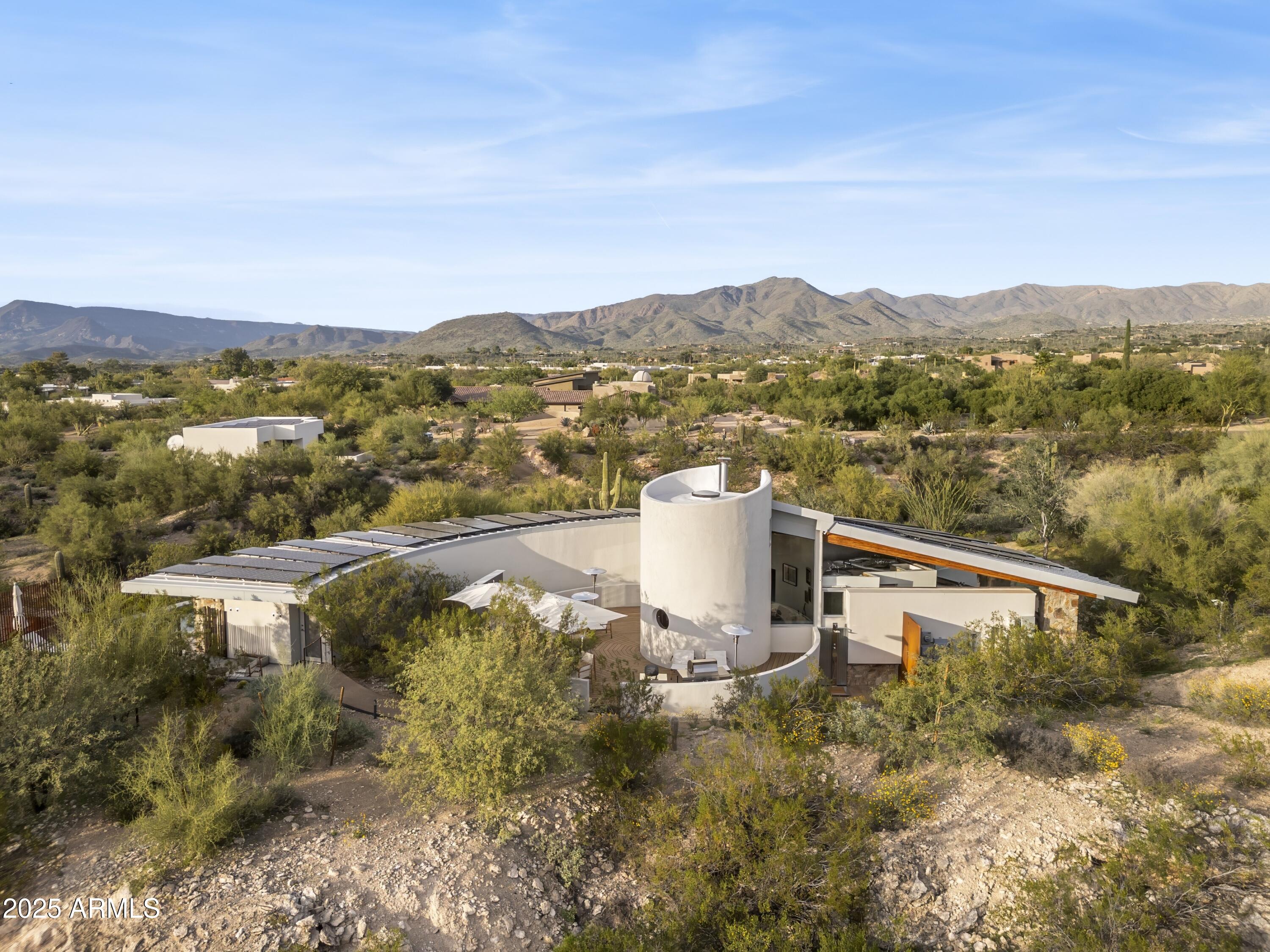 WSJ House of the Week May 22 *A rare opportunity to own a visually striking and deeply livable architecturally significant home in the high Sonoran Desert. This exceptional 2 acre Carefree estate includes a main residence with 2,577 square feet of living space, originally designed and built in 1980, and thoughtfully restored in 2019, by renowned architect and long-time Taliesin professor Michael P. Johnson. The newly built modernist 768 square foot guest house and heated pool were also designed by Michael P. Johnson and built by The Construction Zone, who also executed the restoration on the main house. The main residence features 2 en-suite bedrooms, an office/library, den, powder room, bonus room and laundry room. The guest house features 2 en-suite bedrooms, full living room and kitchen as well as a washer/dryer. Both the main residence and the guest house are equipped with owned solar panel systems that currently offset the property's electricity usage, resulting in no monthly electrical costs. An electric vehicle charging station further enhances convenience and future-forward livability. All major systems were replaced or updated during the 2019 restoration, offering peace of mind alongside architectural distinction. The striking back patio in the main residence, crafted from Cumaru wood (Brazilian teak), features a plumbed gas-powered firepit and a 100-inch retractable projection screen. Though private and secluded, this home is just a 10 minute walk to Civana Wellness Resort and Spa and within close proximity to the shops and restaurants of Carefree and Cave Creek, private and public golf courses, hiking and cycling trails and boating.

Architectural Highlights: The entire property embodies the organic architecture design principles pioneered by Frank Lloyd Wright, where structure, light and land exist in quiet harmony - as expressed through the lens of Michael P. Johnson's mid century aesthetic. Every line, material and sightline has been carefully considered to frame the surrounding desert, capture natural light and create a seamless dialogue between indoors and out. The main residence features warm natural materials, striking butted glass windows and sculptural forms inside and out. The heated pool integrates seamlessly into the landscape and architectural composition. Multiple patios provide distinct spaces for relaxation and entertainment. The guest house provides a striking modern contrast to the main residence, where both original organic architecture vision and modern aesthetic expansion addition are authored by the same architect. The estate's generous acreage provide a sense of seclusion and serenity, with ample space to take in panoramic desert vistas, Black Mountain views, dramatic skies and the ever-changing light that animates the architecture throughout the day. More than a home, this is a living piece of architectural legacy - an authentic expression of Taliesin inspired design, refined over decades and brought forward with clarity and intention.

For the discerning buyer who values design, provenance and place, this is truly a one-of-a-kind offering.