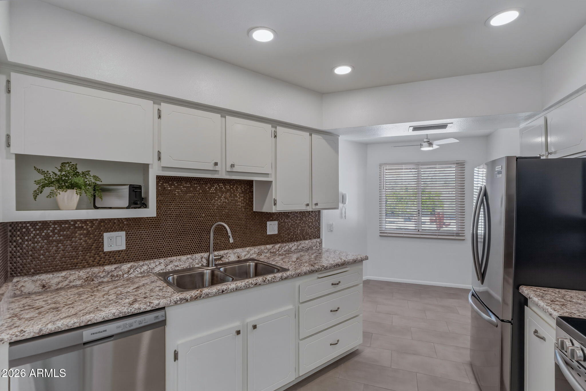 Welcome to this REMODELED home featuring 12x24 tile in the entry and kitchen, opening to a spacious great room. Off the living area, an additional flexible space offers endless possibilities-ideal for an office, den, or guests. The kitchen features recessed LED lighting w/dimmer, iPad and cell charging outlet, brand new appliances and disposal. New plumbing, LED chandelier w/dimmer, ceiling fans with LED lighting & remotes, and stylish hardware throughout.  The oversized bedroom features a generous walk-in closet, while the bathroom showcases a WOW tiled shower and floor mounted toilet.  Inside laundry with new washer/dryer and storage cabinets. Extended garage with epoxy flooring with access to private patio. Abundant storage, community amenities, and golf.  Turnkey investment opportunity
