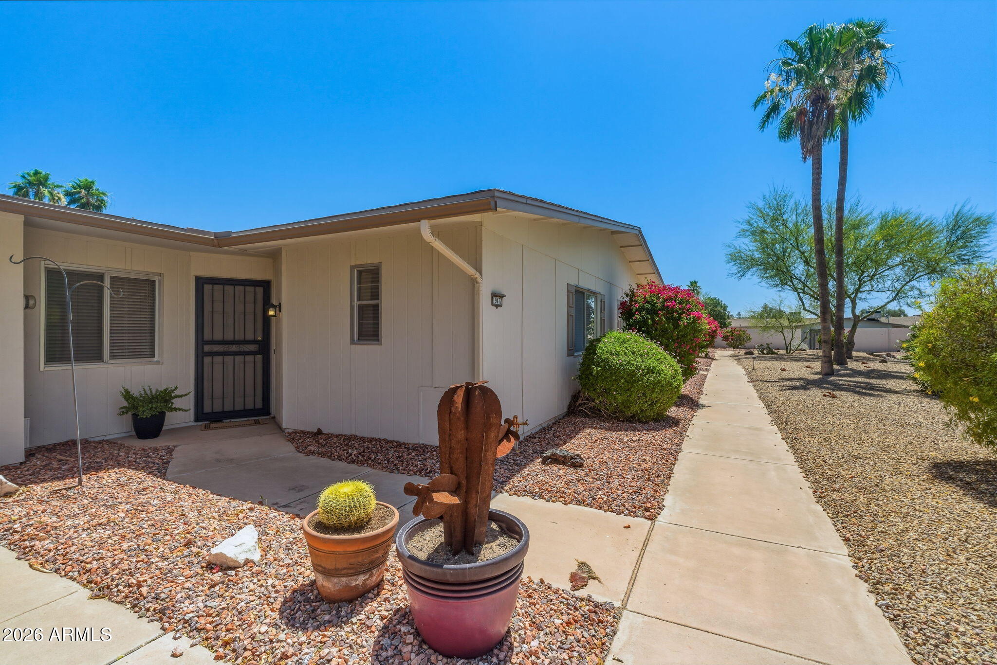 Welcome to this REMODELED home featuring 12x24 tile in the entry and kitchen, opening to a spacious great room. Off the main living area, an additional flexible space offers endless possibilities-ideal for an office, den, or guests. The kitchen features recessed LED lighting w/dimmer, iPad and cell charging outlet and brand new appliances.  New plumbing, LED chandelier w/dimmer, ceiling fans with LED lighting & remotes, and stylish hardware throughout.  The oversized bedroom features a generous walk-in closet, while the bathroom showcases a stunning tiled shower with modern fixtures.  Inside laundry with new washer/dryer and storage cabinets. Extended garage with epoxy flooring with access to private patio.  Abundant storage, community amenities, and golf.  Turnkey investment opportunity.