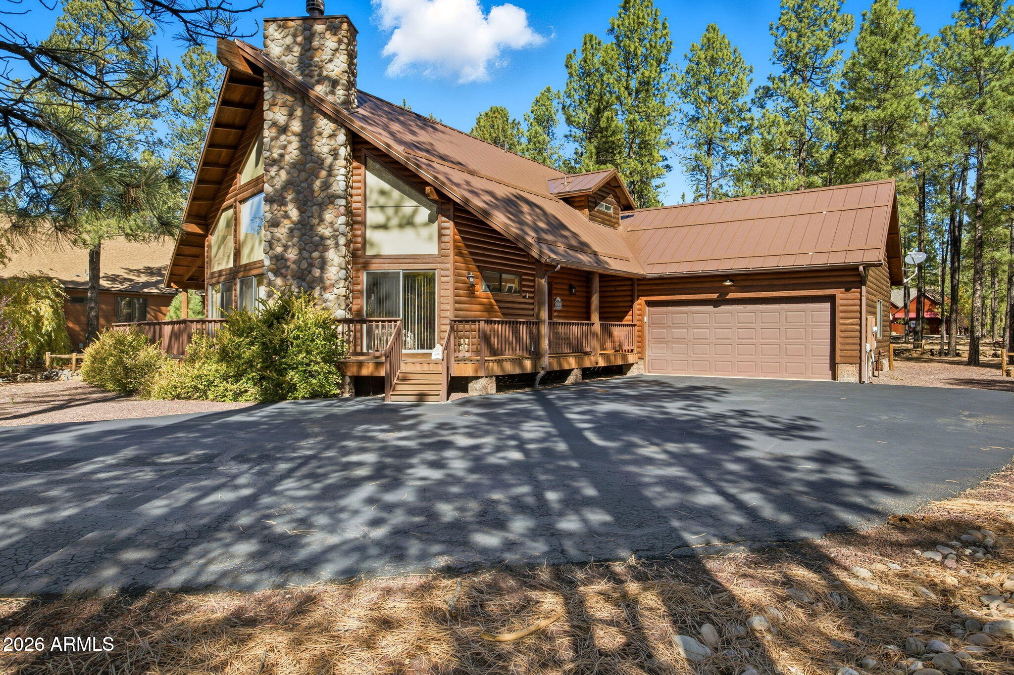 Tucked away in the highly desirable gated Starwood Estates within Pinetop Country Club, this stunning 3 bedroom, 3 bath mountain retreat offers the perfect blend of rustic charm and comfort among the tall pines. The great room welcomes you with soaring wood-plank ceilings, dramatic floor-to-ceiling stone fireplace, and expansive windows that flood the home with natural light and forest views. The open-concept kitchen features granite countertops, ample cabinetry, and a generous breakfast bar--ideal for gathering after a day in the mountains. The spacious downstairs suite provides a peaceful escape with deck access and an ensuite bath, while additional bedrooms and baths offer ensuites for guests. A versatile loft room adds extra living space. Enjoy outdoor living on the wraparound deck overlooking beautifully landscaped grounds and towering pines. With an attached garage, quality finishes throughout, and a prime location near golf, dining, and year-round recreation. Walking distance to national forest trails. This exceptional home is ideal as a full-time residence or mountain getaway.

Living in **Pinetop Country Club** means enjoying a true mountain lifestyle wrapped in a welcoming, close-knit community. Surrounded by towering pines and crisp alpine air, residents love the peaceful setting paired with an active, social atmosphere. The community is anchored by championship golf, scenic walking paths, and easy access to hiking, biking, fishing, and winter recreation. Neighbors often gather for casual rounds of golf, clubhouse dining, and seasonal events, creating a friendly, small-town feel while still being close to dining, shopping, and local amenities. Whether you're seeking full-time mountain living or a relaxing second home, Pinetop Country Club offers a refined yet laid-back lifestyle that keeps people coming back year after year.