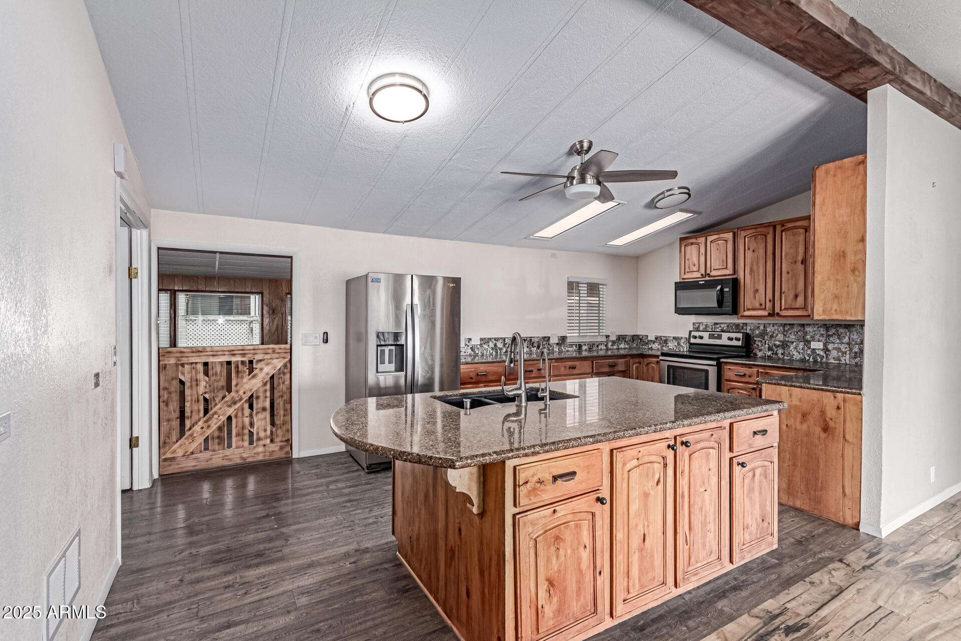 SHORT SALE OPPORTUNITY! MOTIVATED SELLER. Beautifully updated 2-bed, 2-bath home with a split floor plan, solar panels, and modern finishes throughout. The open layout highlights a gorgeous updated kitchen with granite countertops, newer cabinets, stylish backsplash, and a spacious walk-in pantry. Enjoy the large Arizona room with dual exits, leading to a generous workshop and patio. A staircase in the fully fenced backyard brings you to an observation deck with breathtaking panoramic mountain views. New fans and lighting add a fresh touch. Situated on a corner lot maintained in part by the HOA--more space, less upkeep! Move-in ready and sure to impress!