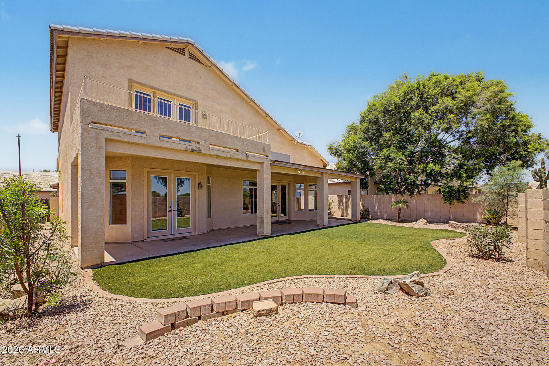 Beautifully situated in the highly sought-after Palm Valley Phase 1 community, this exceptional home offers a spacious and versatile floor plan with two primary suites, making it ideal for multi-generational living, guests, or added flexibility.

Step inside to soaring ceilings and an abundance of natural light that create an open and inviting atmosphere. Neutral tile and carpet throughout provide a timeless backdrop to complement any style, while charming bay windows add character and enhance the home's bright, airy feel. Thoughtfully designed with plenty of storage space, this home combines comfort and functionality at every turn. Enjoy Arizona living from the covered patio, perfect for outdoor dining and relaxation, or take in the incredible views from the private balcony. The epoxy-coated garage floor adds a polished touch and durability for everyday use.

Residents of Palm Valley enjoy access to outstanding community amenities, including a sparkling pool, recreation center, and playground, all within a neighborhood served by top-rated schools.

Offering beautiful living spaces, stunning views, and an unbeatable location, this is a home you'll be proud to call your own.