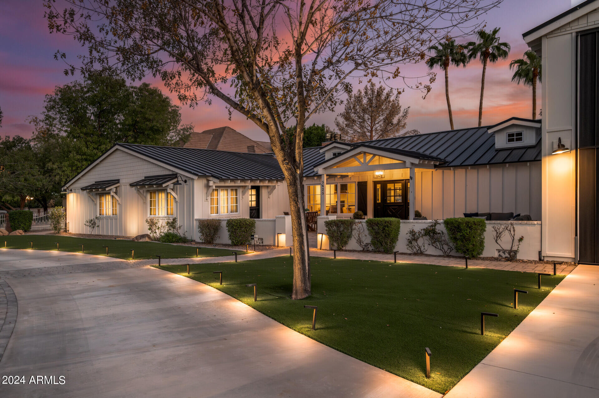This quintessential Arcadia home is every family's dream. This sprawling ranch, located on the coveted Exeter Blvd in the heart of Arcadia, is as grand as it is charming. Enter through a custom Dutch entry door into a home filled with vintage wood flooring, beamed ceilings, and a chef's kitchen boasting custom cabinetry, Carrera marble countertops, high-end appliances, two dishwashers, a farmhouse sink, and a walk-in pantry with a second fridge.
The versatile den is an ideal space for both kids and adults or can be transformed into a spacious mother-in-law suite. The Arcadia Proper cottage-style home offers a split floor planwith five bedrooms and six bathrooms. The primary suite includes a cozy fireplace, an oversized closet, a dual sink vanity, and a luxurious walk-in shower with a... ...clawfoot tub.

A wall of glass sliders opens to the magnificent grounds, featuring stunning resort-style landscaping, a heated pebble tec pool and spa, and a covered patio. There's plenty of space fora sport court, bocce ball, pickleball, or even a soccer pitch, making this home perfect for hosting birthday parties, cocktail gatherings, weddings, and outdoor soirées.
Additional features include a massive laundry room, an exposed red brick wine room, and an air-conditioned garage that fits nine cars.  Truly a car enthusiast's dream. The prime location offers easy access to the best shops, restaurants, and amenities in both Arcadia and Old Town Scottsdale.