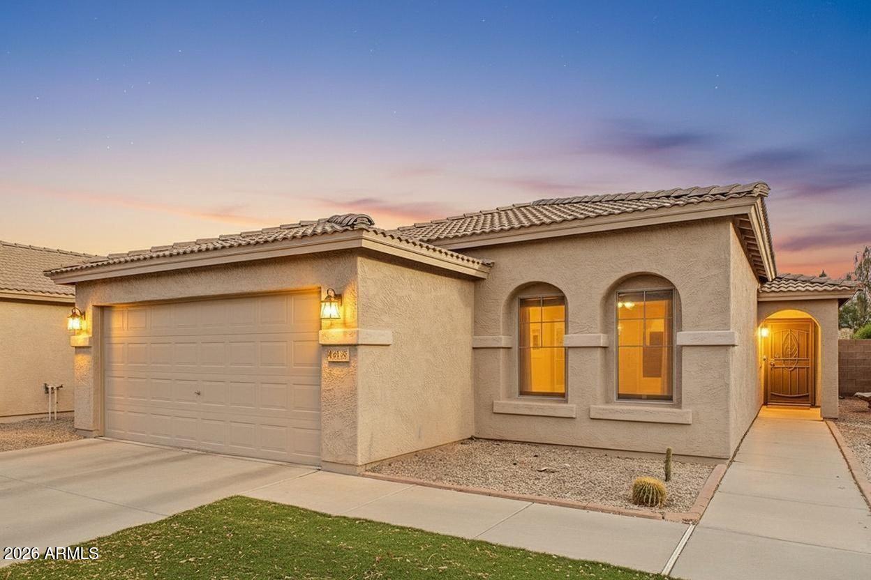 Unique and desirable layout in Rancho El Dorado featuring a cozy fireplace, stylish stone accent wall, and a bright Arizona room perfect for relaxing or flexible use. This well-maintained home offers comfortable, open living with a functional flow that feels both inviting and practical. The primary bath includes an easy-access shower instead of a tub for added convenience. Low-maintenance desert landscaping and synthetic grass front and back provide great curb appeal. Enjoy a 2-car garage, block fencing, and easy freeway access. A great blend of comfort, style, and convenience in a sought-after Maricopa location.