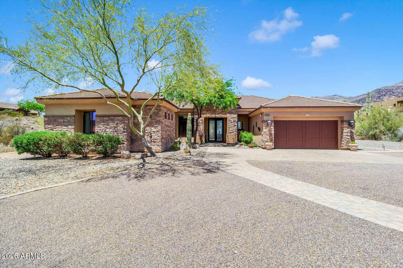 Beautifully updated custom home with a private casita on a nearly one-acre prime lot with NO HOA.

Extensively updated with elegant quartz bathroom counters, new faucets, fixtures, and lighting; refinished cabinetry accentuated with oil-rubbed bronze hardware and soft-close components; fresh interior paint; smart Wi-Fi thermostats; a 10-ft Levolor remote-controlled auto shade; a full KitchenAid stainless steel appliance package; and more.

A grand entry welcomes you with 10-ft-tall double cast-iron doors and dramatic entryway lighting. The warm, inviting interior features a spacious open floorplan with soaring 12-ft ceilings and solid-core 8-ft doors throughout. The enormous gourmet kitchen includes granite counters, knotty alder cabinetry, a 5-burner gas cooktop, and a brand-new stainless steel appliance package. The kitchen opens to the large living room -- a perfect space for entertaining..
This immaculate home has 4 bedrooms and 3.5 bathrooms. The ideal split floorplan offers two bedrooms and a full guest bath on one side, with a generous primary suite on the other, complete with private patio access, an oversized deep soaking tub, separate shower, and an enormous walk-in closet. Additional spaces include a formal dining room, laundry room, half bath for guests, a cozy den, and of course the private casita with ensuite bathroom and its own separate entrance -- perfect for guests, rental income, or multigenerational living.

The resort-style backyard features an easy-maintenance 18-ft Passion Swim Spa (Activity Two model), ideal for exercise or relaxation. Enjoy a large covered patio, custom pergola with lighting and electric, built-in BBQ island with custom tiled bar top, sink, and refrigerator; paver patios and walkways; over 800 sq ft of artificial turf; and low-maintenance, picturesque desert landscaping with drip system and low-voltage lighting in both the front and back yards. A newly chip-sealed driveway completes the exterior.

Additional upgrades include a newer water heater, two newer Bosch AC units, a wired security system, owned soft-water system, and owned R/O drinking water system. Plenty of room for RV parking and toys.

This home is absolutely stunning and offers true turnkey, low-maintenance Superstition living.