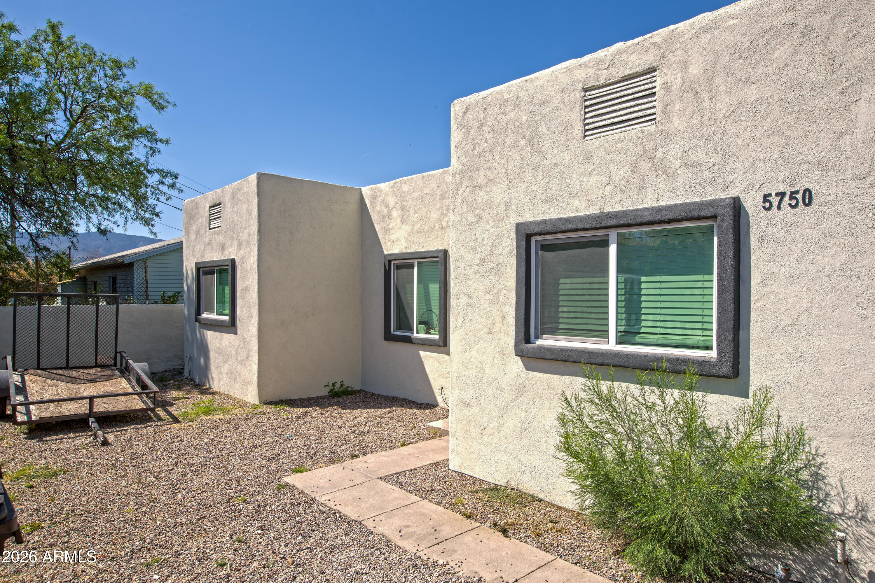 Explore this move-in ready, fully remodeled home. Sitting atop a hill, the home features panoramic mountain views. The interior boasts a sleek, modern design. Upgrades include brand-new stucco, new torched-down roof, & new HVAC. When you step inside, you're greeted by a spacious living area & a renovated kitchen w/ new cabinetry, quartz countertops, & stainless-steel appliances. The updated bathroom features a tile surround shower w/ new vanities and toilets. Additional upgrades include new windows, fencing, and an indoor laundry area for added convenience. The bright, open layout is enhanced by a new Arcadia door leading to the porch and freshly built steps for seamless indoor-outdoor living. Don't miss this chance to own this beautifully remodeled home with breathtaking views.