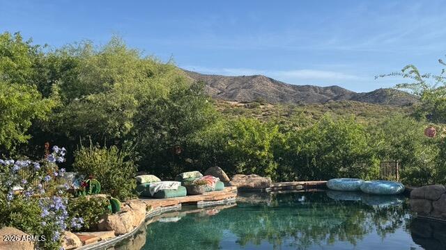 Custom pretty pueblo ideally seated on 3.5 acres for total privacy with multiple outdoor lounge/dining areas and spectacular vistas/views of Four Peaks, Weaver's Needle with Tonto National Forest surrounding. Three en-suite bedrooms, dedicated office with new wood flooring, new HVAC's, new appliances and new custom interior and exterior lighting. Botanical secret gardens curated for the enjoyment of all in residence enchant year round. The pool patios are totally private with covered dining multi lounge areas that capture the Sonoran skies at their most beautiful. Remodeled primary suite and guest suite with hand painted tile in both. This offering includes 2 parcels.