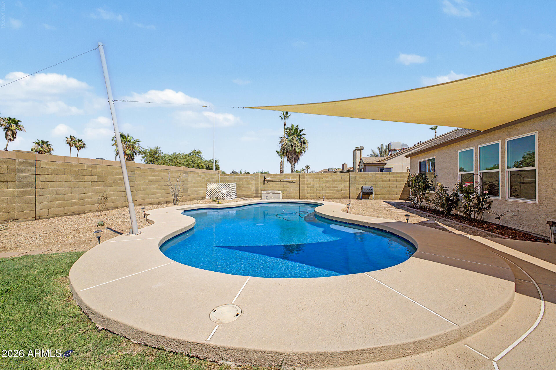 This exceptional 3-bedroom, 2-bathroom home offers the perfect blend of style, comfort, and freedom to do as you please with no HOA overlords. The thoughtfully designed split floor plan offers privacy by separating the primary suite from the secondary bedrooms. A stunning kitchen is the heart of the home, serving as a focal point for gathering & entertaining. Step outside to a beautifully appointed backyard featuring a gorgeous pool w/ shade sail, a covered patio, and flexible space to create your dream garden, play area, or extended outdoor living area. The corner lot location provides a larger than expected yard that is only limited by your imagination. No neighbors behind or to the immediate west, offering even more privacy. This is a truly remarkable property that is sure to impress.. Recent updates include windows and back and garage entry doors, roof, rv gate, raised wall height, water heater, pool resurface, garage door, and carpet in just the right places.