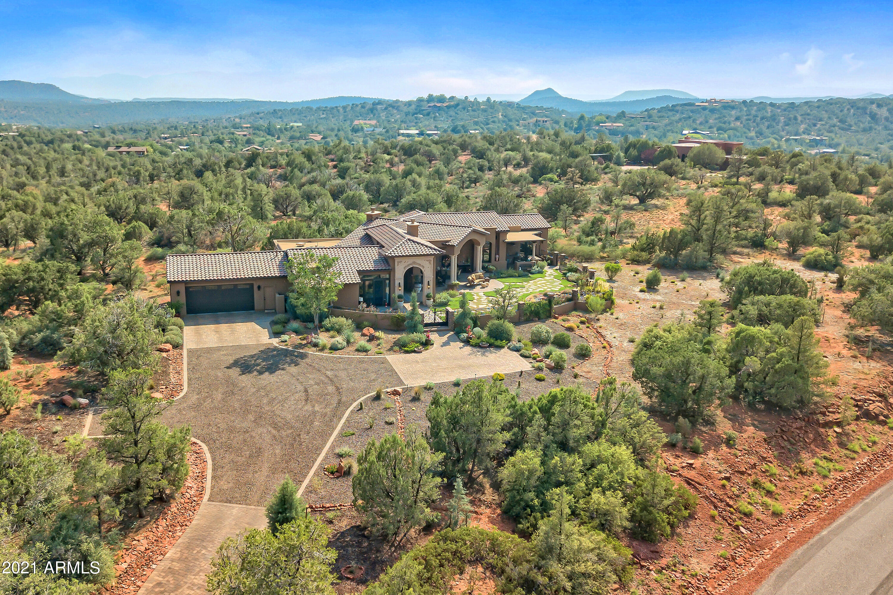 One of Sedona's most astonishingly beautiful homes... Exquisite luxury & the Ultimate in red rock panoramic views. Inside & out, this extraordinary estate in exclusive, gated Foothills North delights with its Contemporary Mediterranean architecture, elegant design features, & superb appointments. It also surprises with its charm & wry whimsy. Enter the expansive walled-in courtyard & find a covered patio unlike any in Sedona â€'' an outdoor living room with ceiling fans, heaters, fireplace, & TV - facing a marvelous Boynton Canyon vista. The owners spared no expense in making this home a showplace of the highest quality, from Venetian Plaster walls to the incredible exterior & interior stone work to the 16th century Carrera Marble sink in the Powder room. Click ''MORE'' for full details