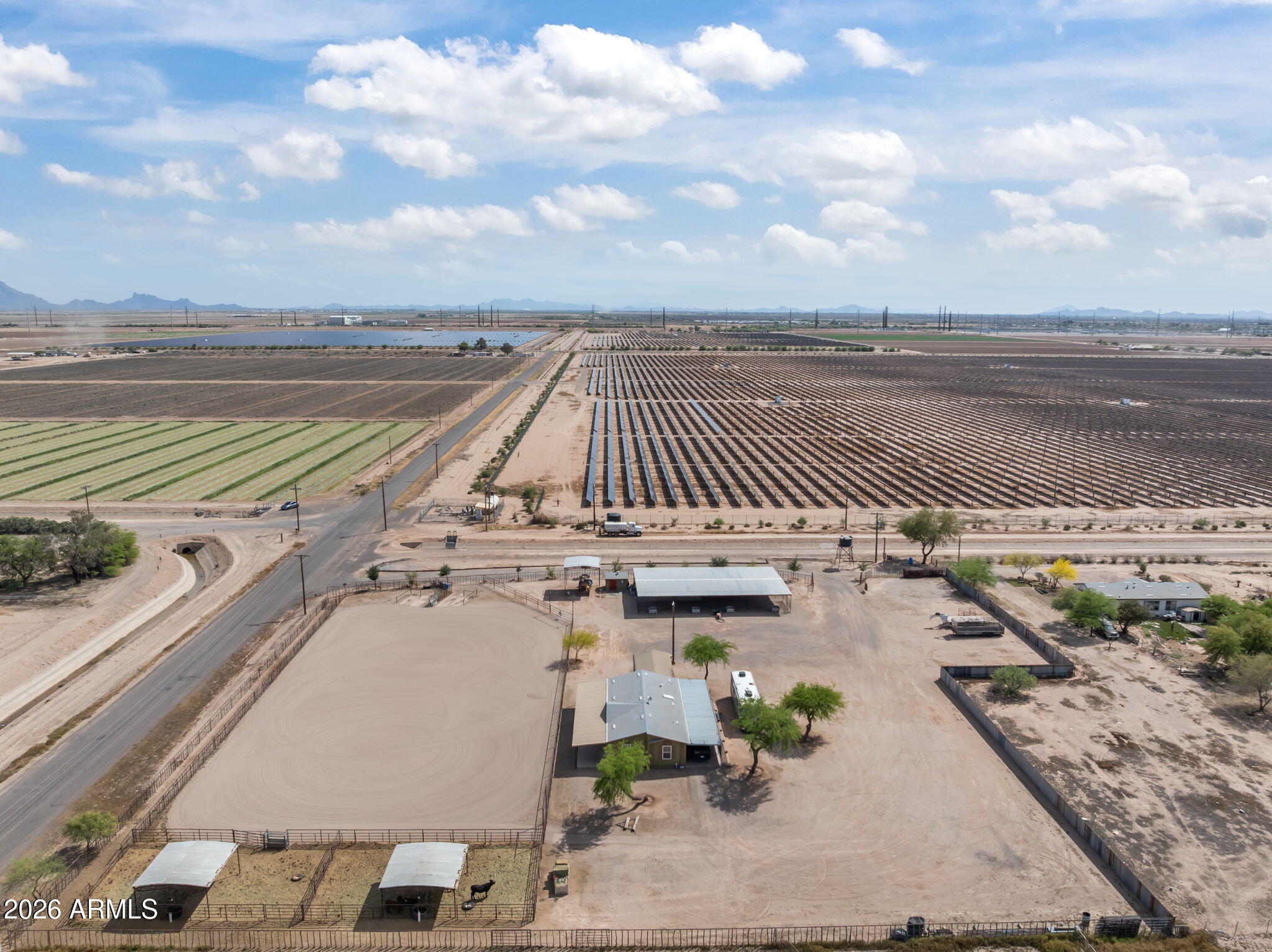 Situated on 4.04 fully fenced acres in a great location, this well-equipped horse property offers a functional setup designed for both everyday use & roping. The property features a full-size roping arena, 4 large steer turnouts with shades, & an 8-stall mare motel with 20x20 stalls & a breezeway for easy access & efficient operation. Additional improvements include a covered hay shed, privacy fencing, & ample space for trailer parking w/ room to expand or add additional pens & 1 RV hook-up. The home offers 3 bedrooms and 2 bathrooms & has been updated throughout, providing a comfortable & refreshed living space. Additional features include a covered carport & a covered patio, perfect for relaxing & watching the roping.Solar Subsidy to transfer to new owners $1500 a year income (June) Recent upgrades include all new windows and updated lighting throughout the home, new flooring & paint cabinets enhancing both efficiency and overall appeal.Water is a strong asset with a private well and a second capped well already in place. This property provides a great combination of usability, expansion potential, and a ready-to-go horse setup in a desirable rural setting.