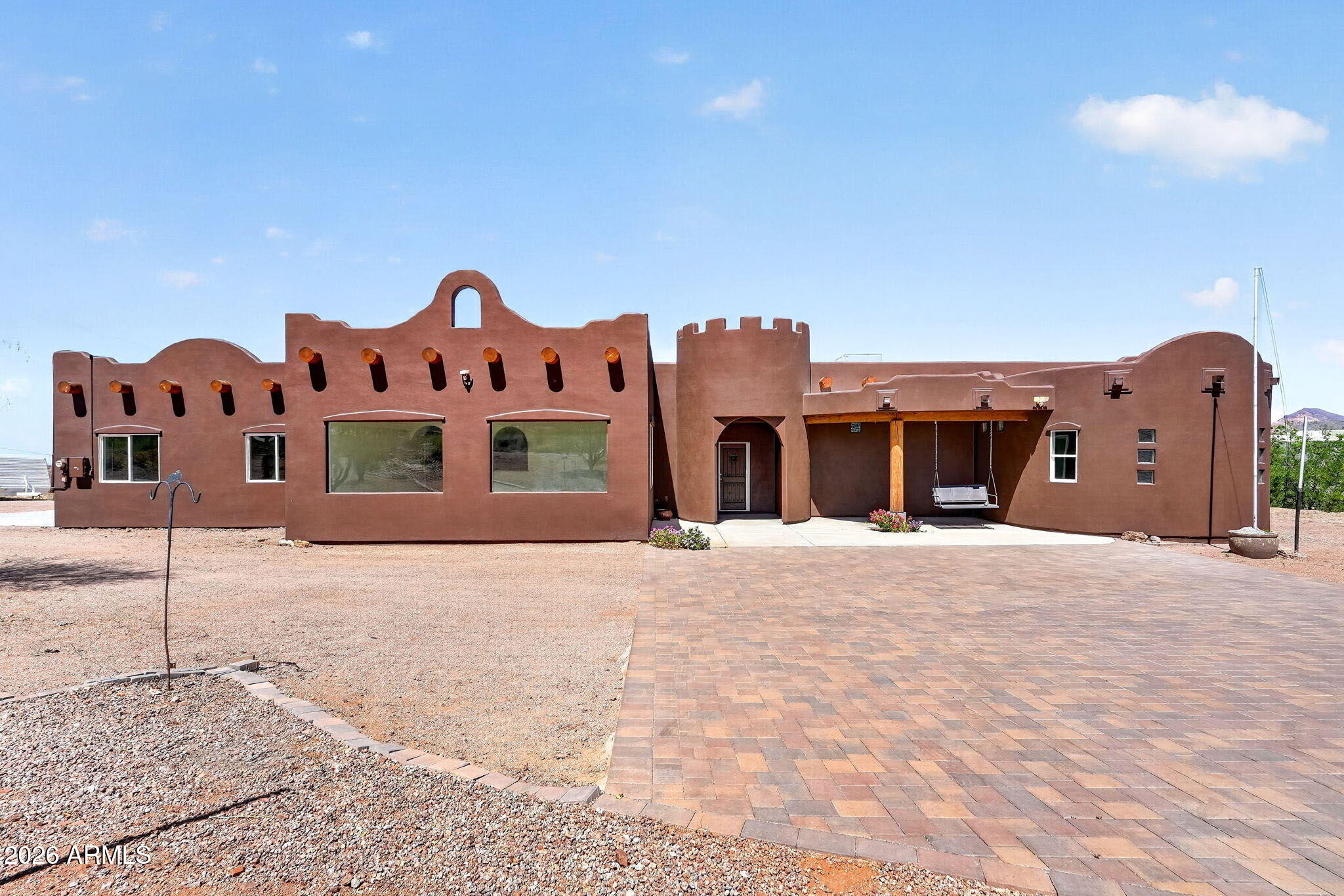 Custom Santa Fe Style Home on a 1.25-acre horse property with no HOA! GREAT views of Superstition Mountain, 2,490 square feet living, 3 bedroom, 2-1/2 bath, 2-car-oversized garage. The home was built in 2019 on the western slope of the Superstition Mountain Range and has breathtaking, close-up views of Superstition Mountain and at an elevation of 1,985 feet you'll enjoy the incredible views of the valley's city lights along with Four Peaks and Goldfield Mountains. Home has all-natural stone floors. Lots of architectural features throughout interior and exterior of home including a huge master bedroom and a natural stoned round 2-person walk-through shower and garden tub feature. Owner owned 8kWh solar system. Built energy efficient including 2 X 6 walls. 10 foot ceilings throughout home.