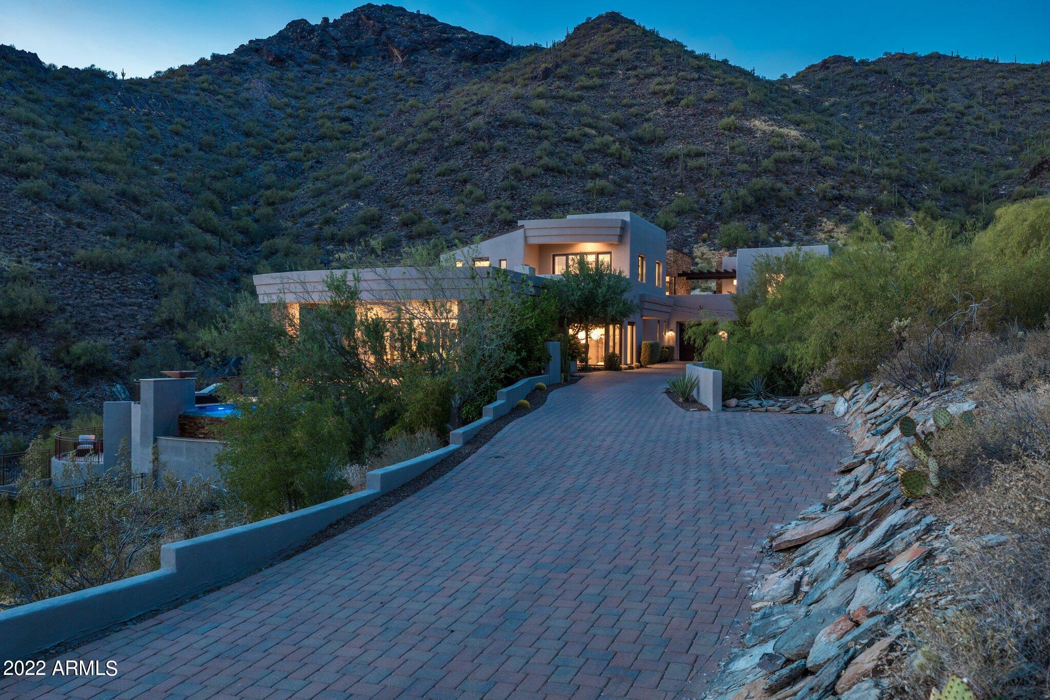 Looking for THE BEST VIEWS & COMPLETE PRIVACY? You will not find another home in The Valley for under $10mm offering anything equivalent. Perched atop Paradise Ln, this is the highest elevated & most exclusive home in all of MMR. Proceed thru the privately gated driveway & your approach is surrounded by the breathtaking & majestic mountain landscape. This freshly painted custom built home is ideally nestled in the McDowell mountains yet minutes away from all that North Scottsdale has to offer. Inside is just as jaw dropping. The main level has a gorgeous chef's kitchen w/ Sub Zero and Wolf appliances overlooking the huge family room, an elegant dining w/ glass enclosed temperature-controlled wine room, a charming powder room, 3 ensuite bedrooms & an oversized laundry w/ drop zone & workstation. Upstairs is the grand primary suite w/ a private patio showcasing those fantastic city views. The primary bath features a soaking tub, dual showers w/ 1 steam, as well as a large walk-in closet w/ a 2nd washer/dryer. There's also an exercise room & dedicated office w/ a slider that offers direct access to the back patio & fireplace. Adjacent is the guest casita, providing everything you need including a mini kitchen. The multiple outdoor spaces are plentiful highlighted by an infinity edge pool, spa, BBQ station w/ pizza oven, firepit & new artificial turf in front & back. As if that wasn't enough, a huge flex room is situated on the lower level that has a sauna, full bath & w/d combo. A 4-car garage & ample storage ensures this home checks all the boxes. A retreat like none other, your own secluded sanctuary.