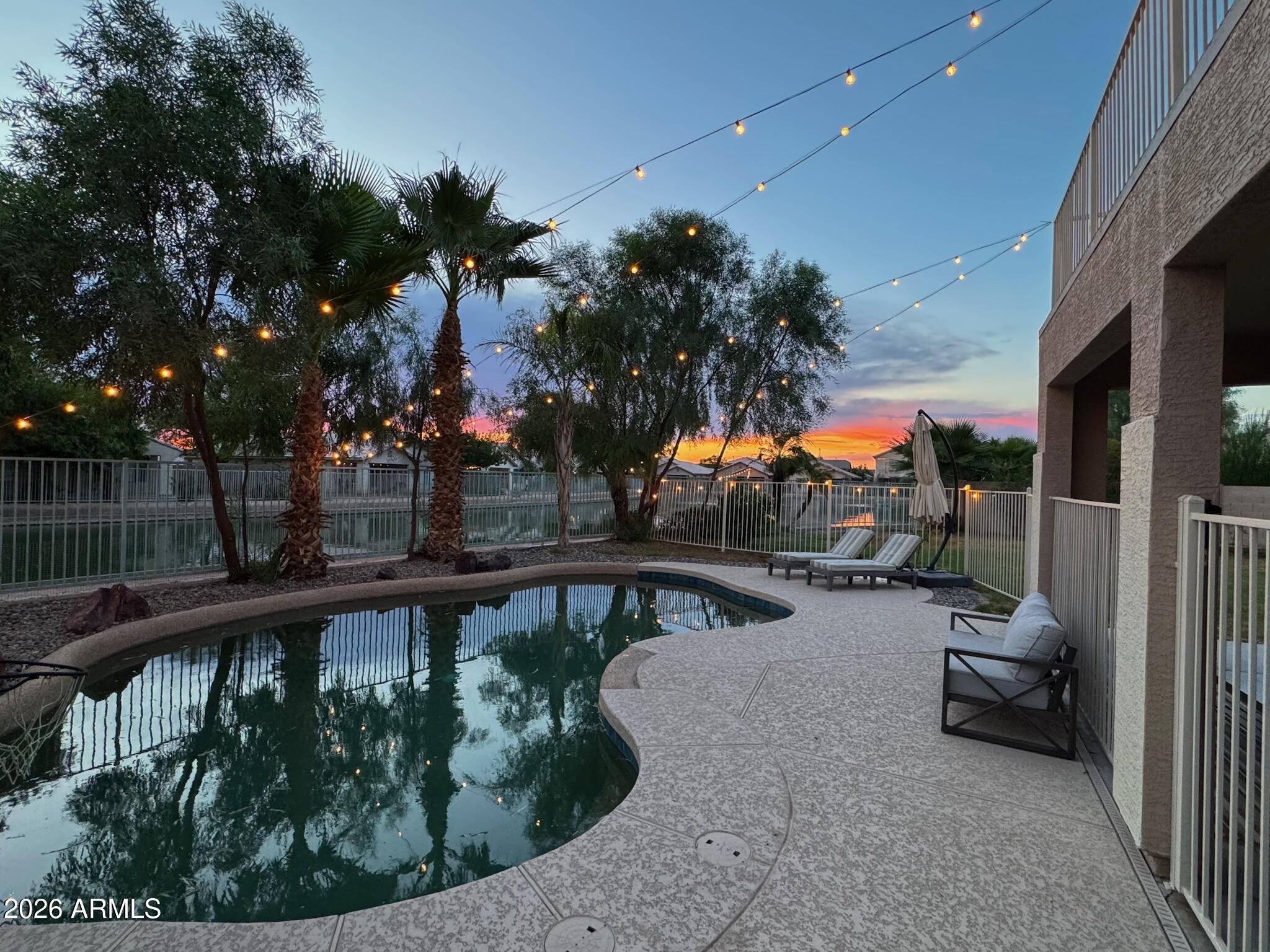 Lake views in the desert? Yes, and you'll want to see them in person. Set on an oversized waterfront cul-de-sac lot in the Crystal Gardens lake community, this 5-bed, 2.5-bath two-story in North Avondale comes with a backyard you won't want to leave. The primary suite looks out over the water and opens to a private balcony. A main-level bedroom with a half bath close by makes hosting simple. The pool was updated in 2026 with new Pebbletec, tile, and decking, & solar keeps energy costs down. Grand entry, soaring ceilings, granite kitchen counters, multiple living spaces. Roof and HVAC (2022), exterior paint (2026). Minutes from the 101, I-10, Shopping, dining, State Farm Stadium, Westgate, & the new VAI Resort & entertainment. Waterfront homes here don't sit long, so see it while you can. 5 Bedrooms | Waterfront | Pool | Cul-de-Sac | Roof & HVAC 2022
Home includes an orange tree, lemon tree, pomegranate shrub, blackberry bush...yum