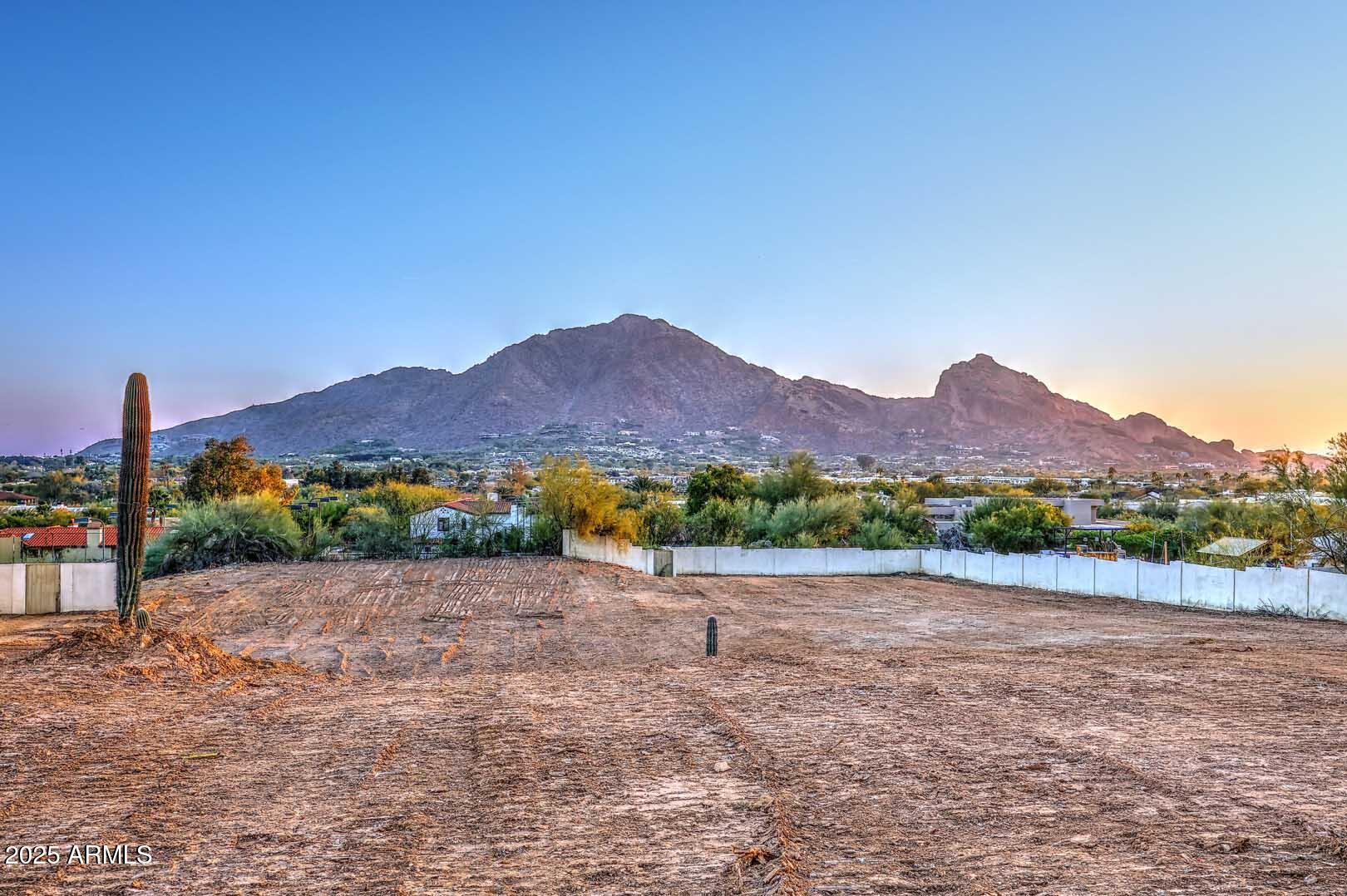 A phenomenal Paradise Valley homesite which showcases Camelback Mountain and the Monk. This lot offers a picturesque panoramic view plus city lights from this outstanding North / South situated property. Another great aspect of this elevated setting is that the lot is NOT within the Town's Hillside Development Area and therefore the architectural and building process in PV would be quicker.